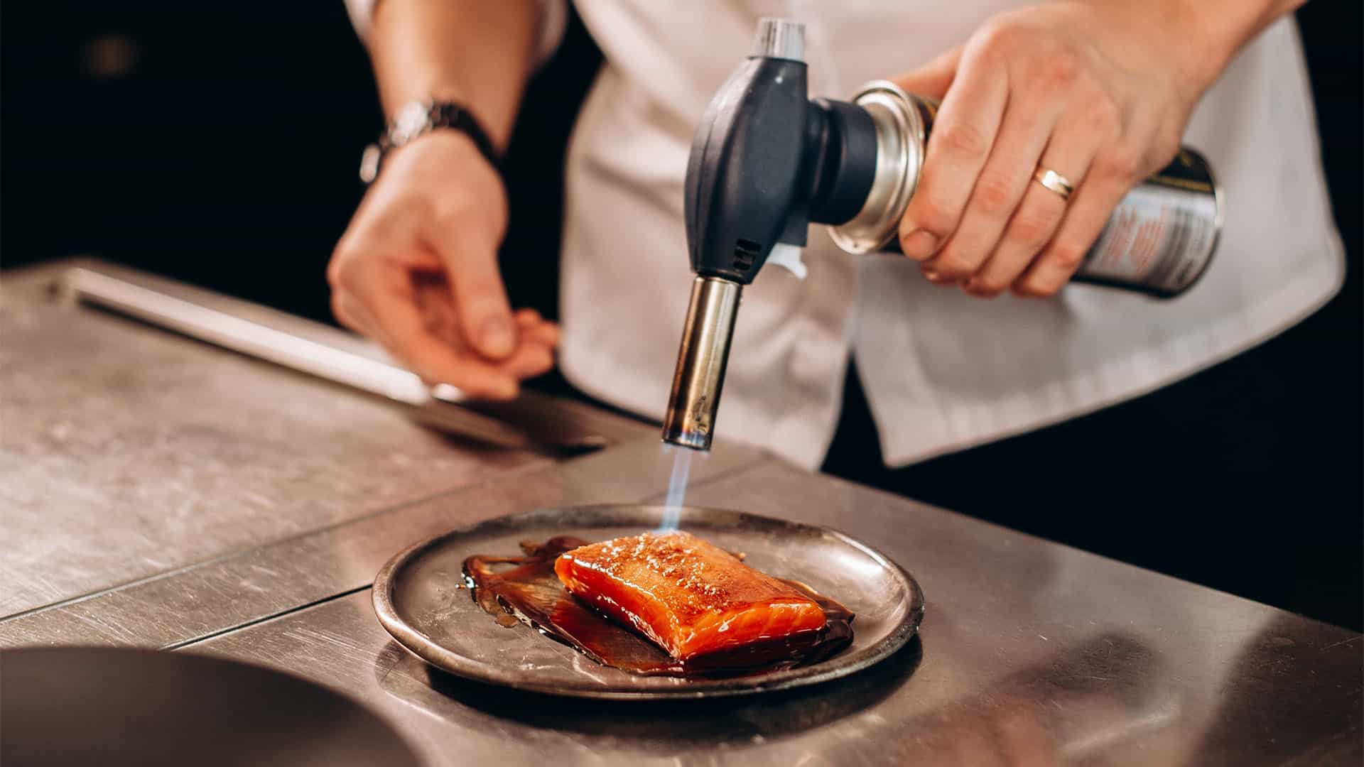 using a kitchen torch.