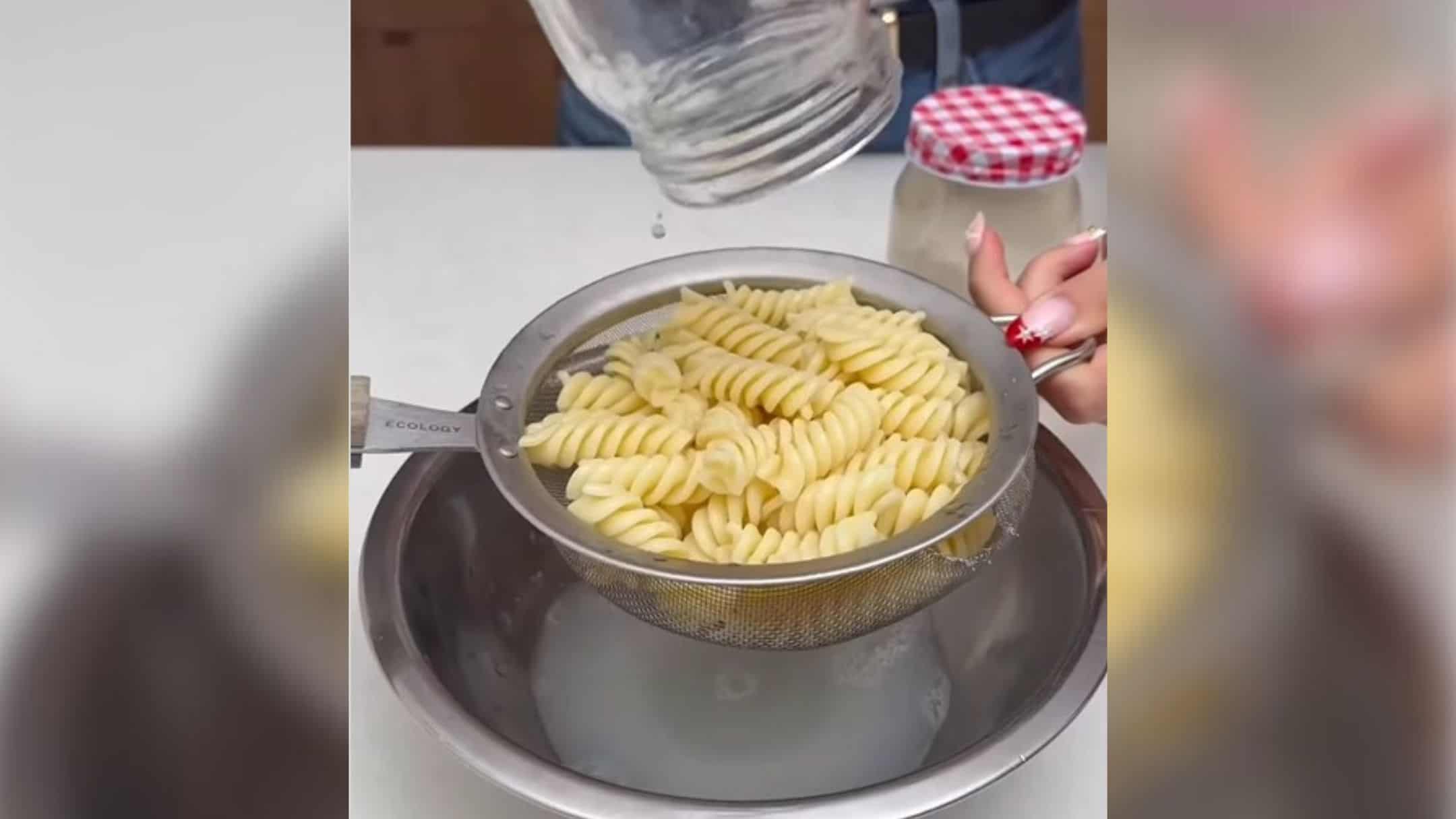 pouring pasta on strainer