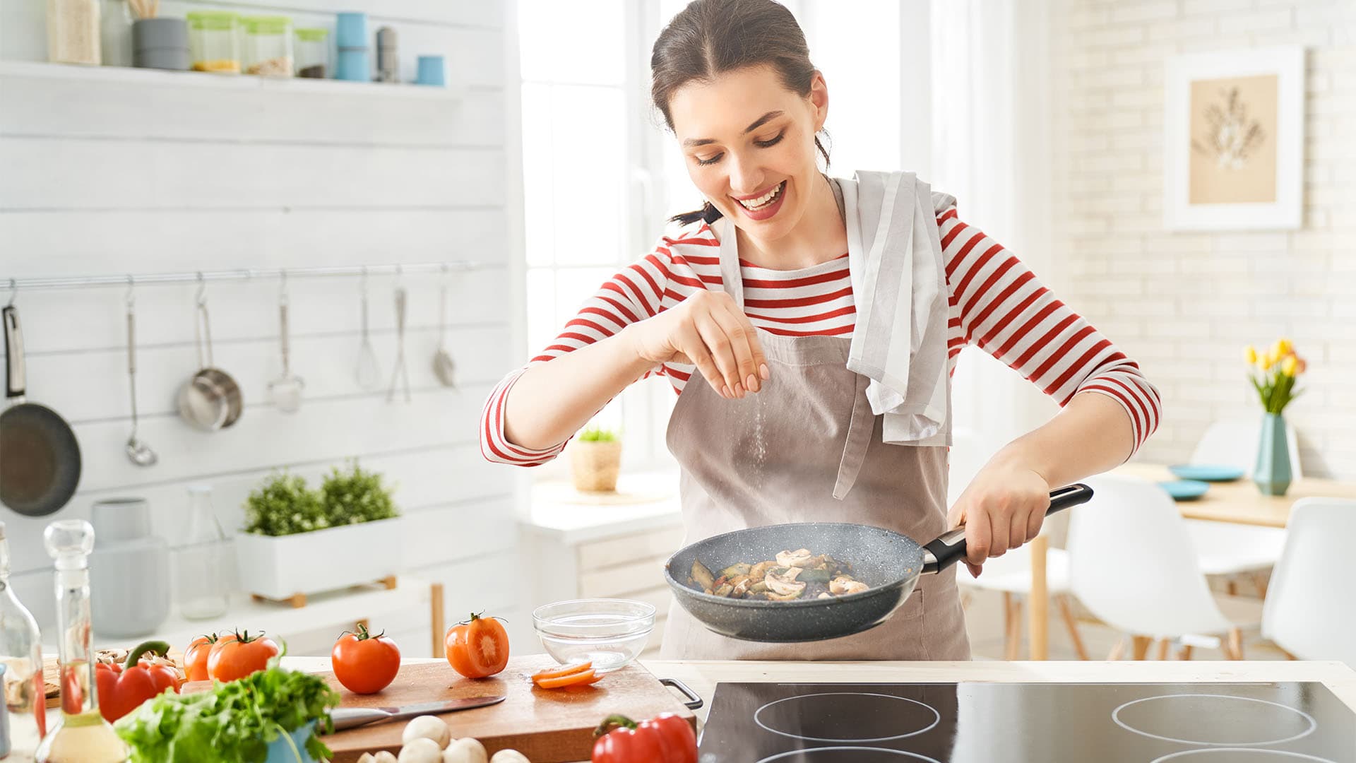 woman cooking in a kitchen.