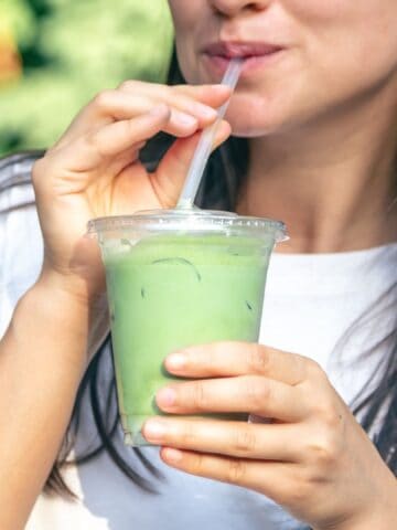 woman drinking matcha latte