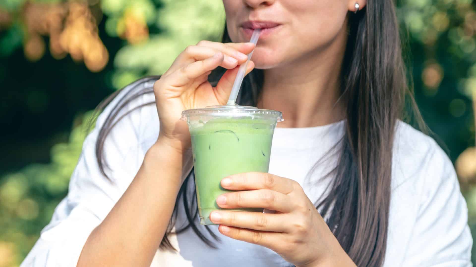woman drinking matcha latte