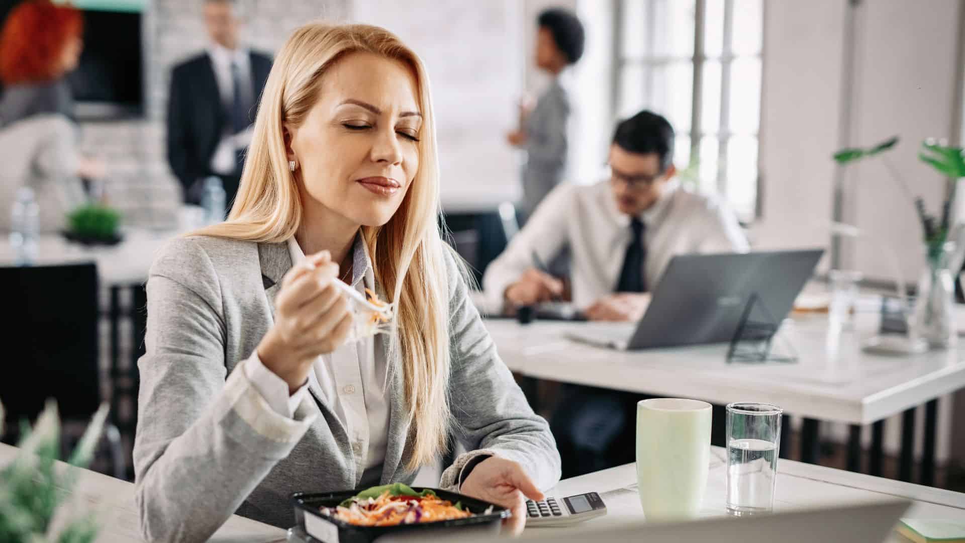 woman enjoying her lunch in office