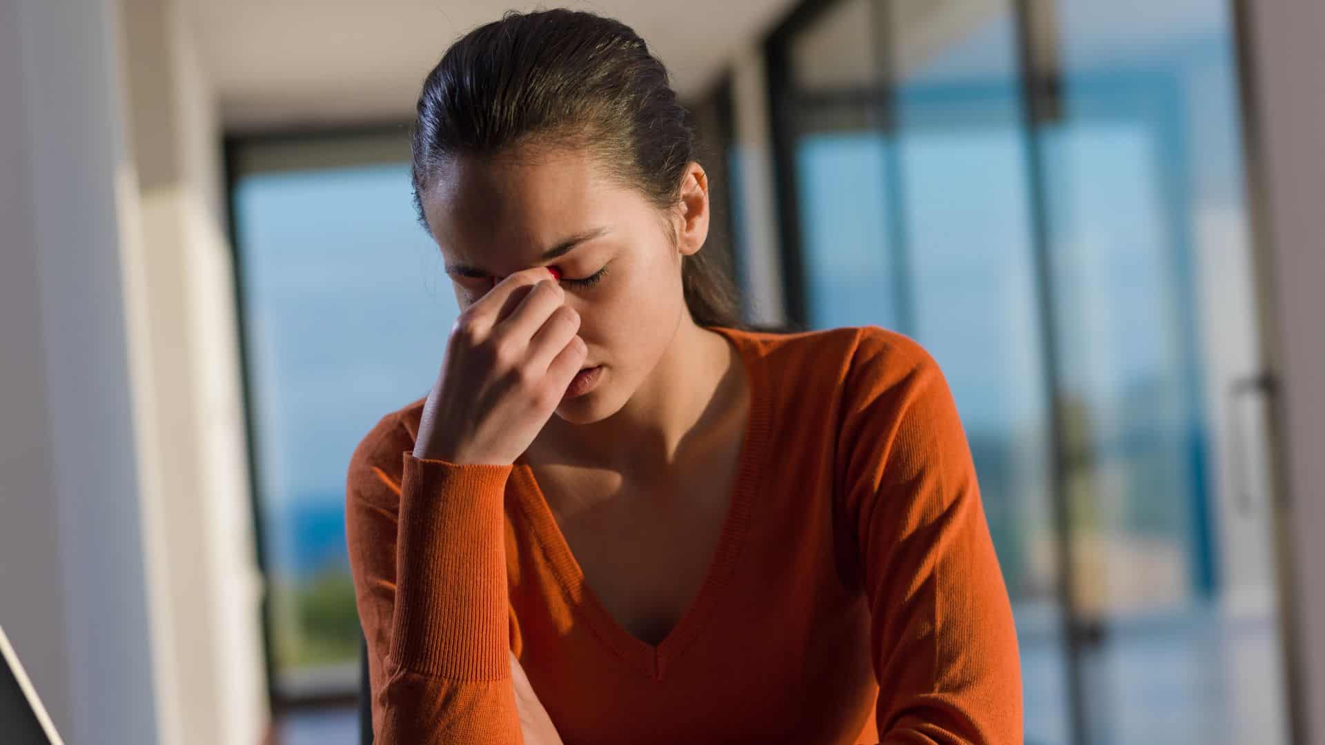 woman feeling sad sitting in office