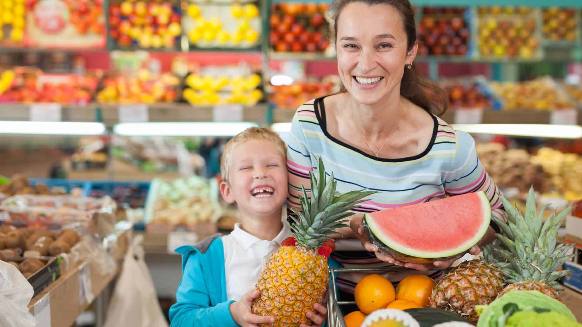 woman with her kid holding fruits