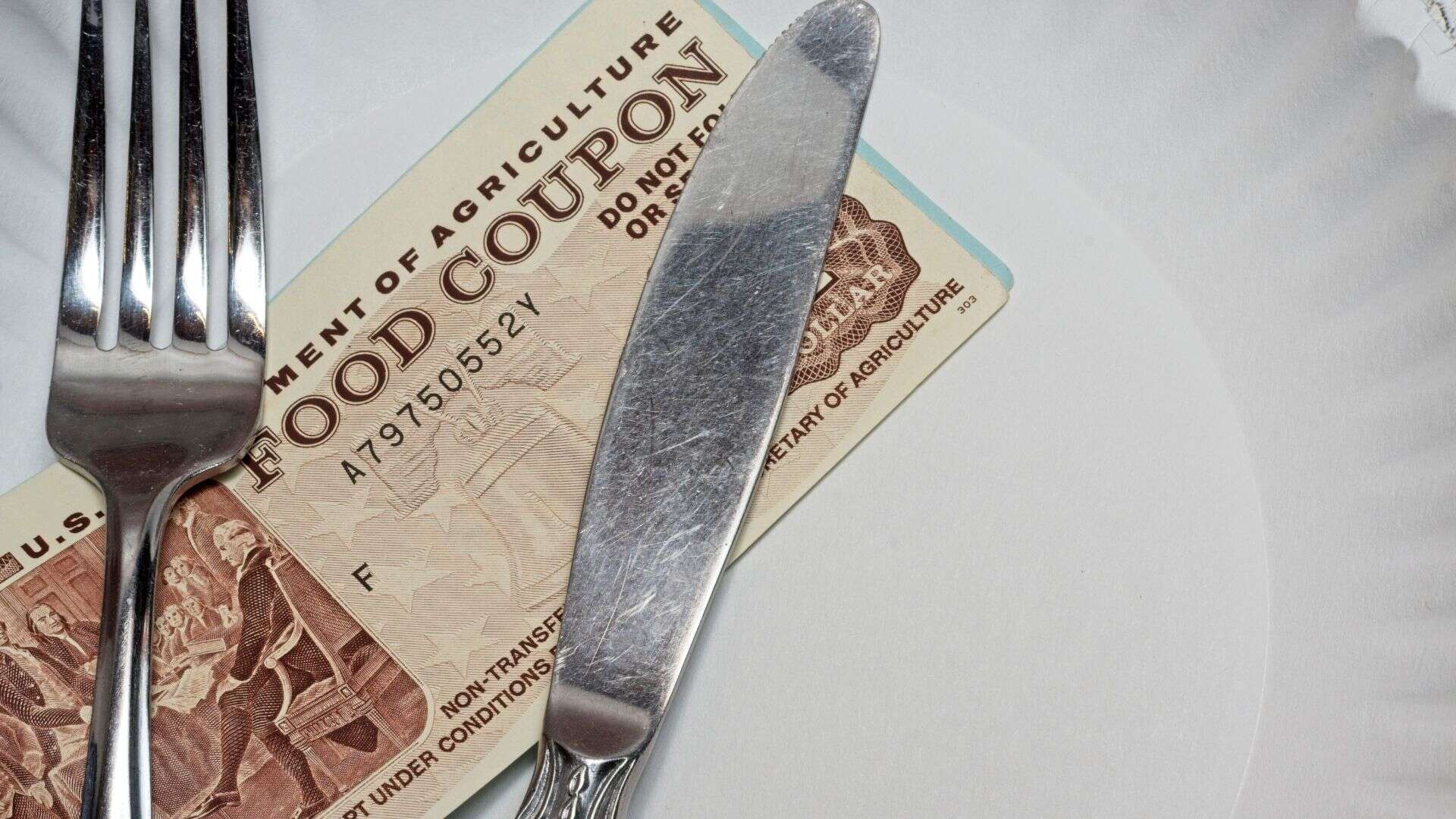 Food coupon on a paper plate with fork and knife