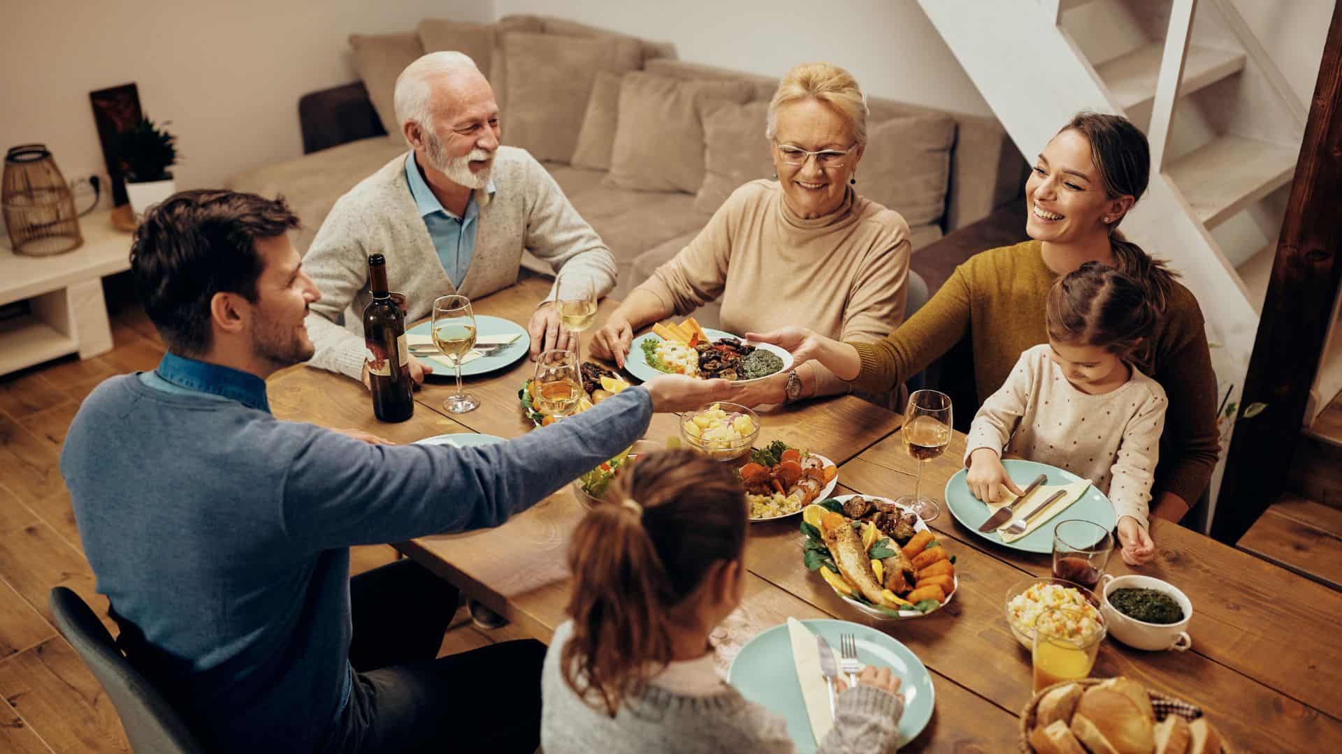 Happy extended family having dinner at dining table at home