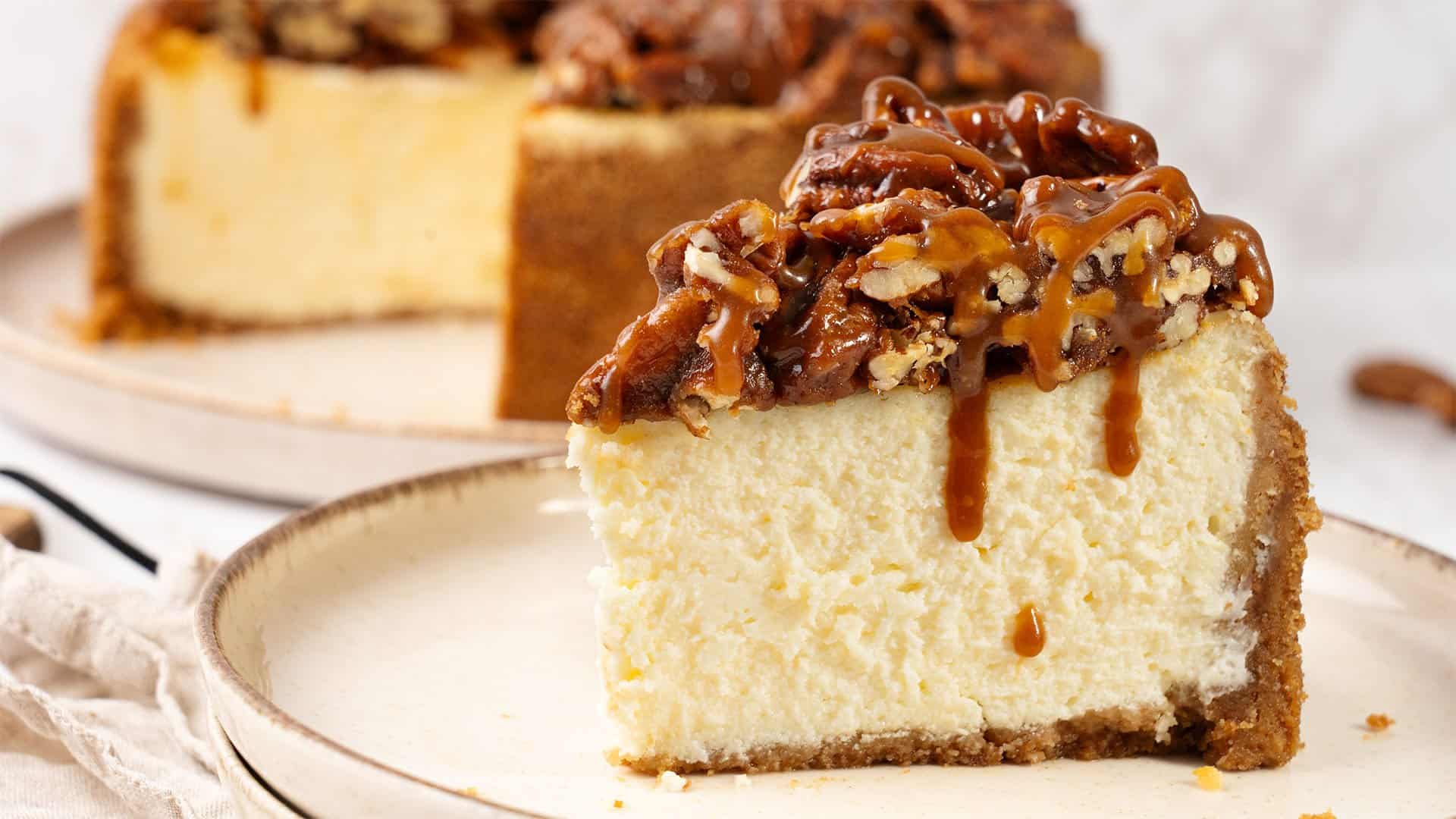 A slice of Pecan Pie cheesecake on a plate.