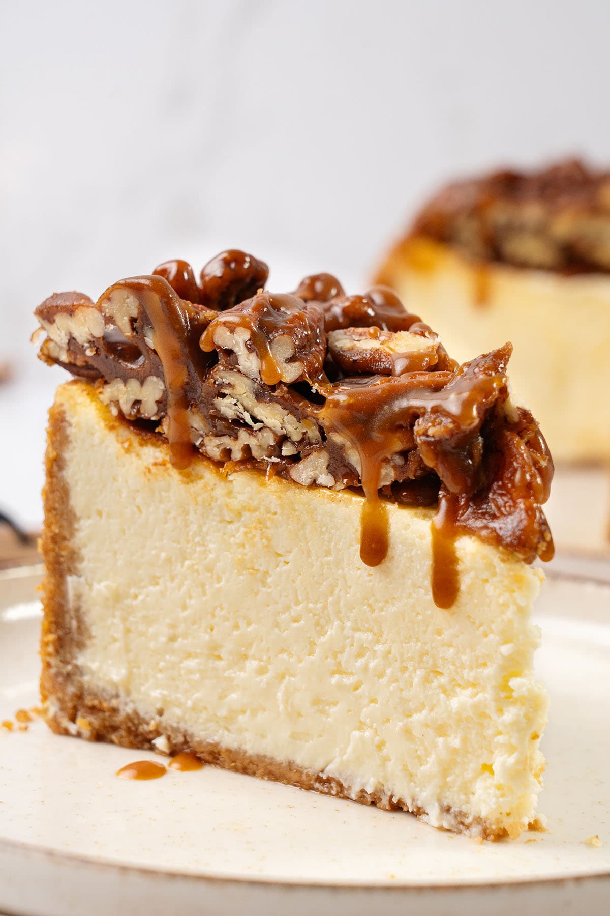 A slice of Pecan Pie cheesecake on a plate.