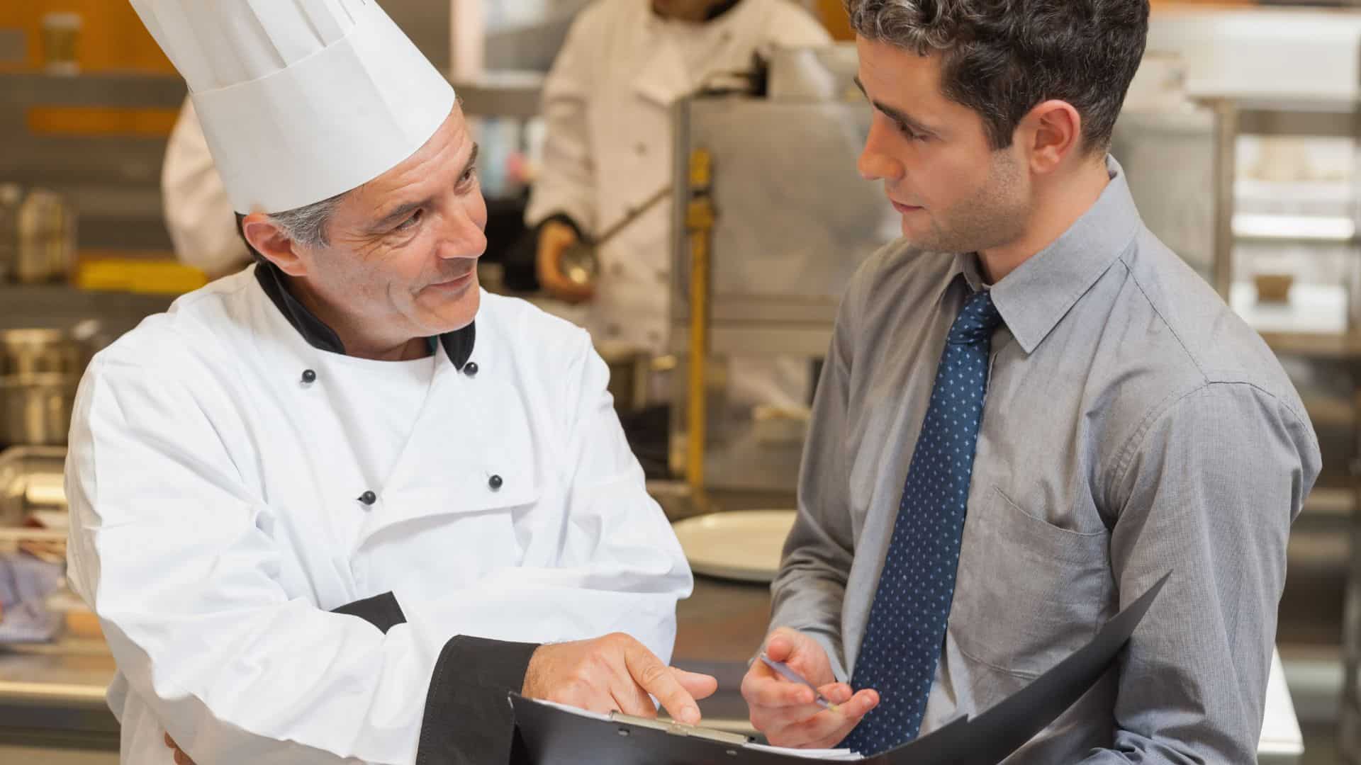 chef and man discussing menu in the kitchen