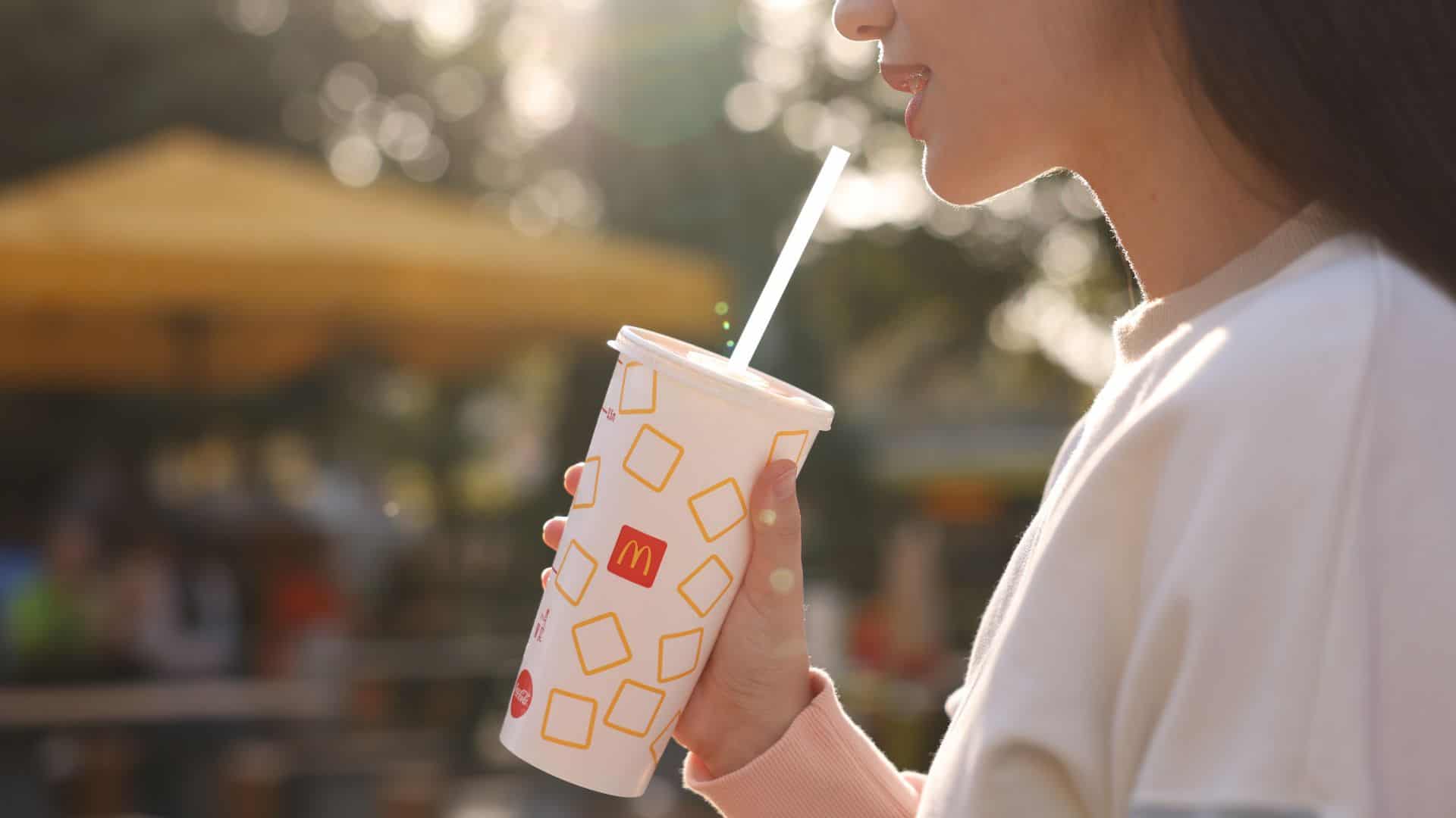 woman drinking mcdonald's rink