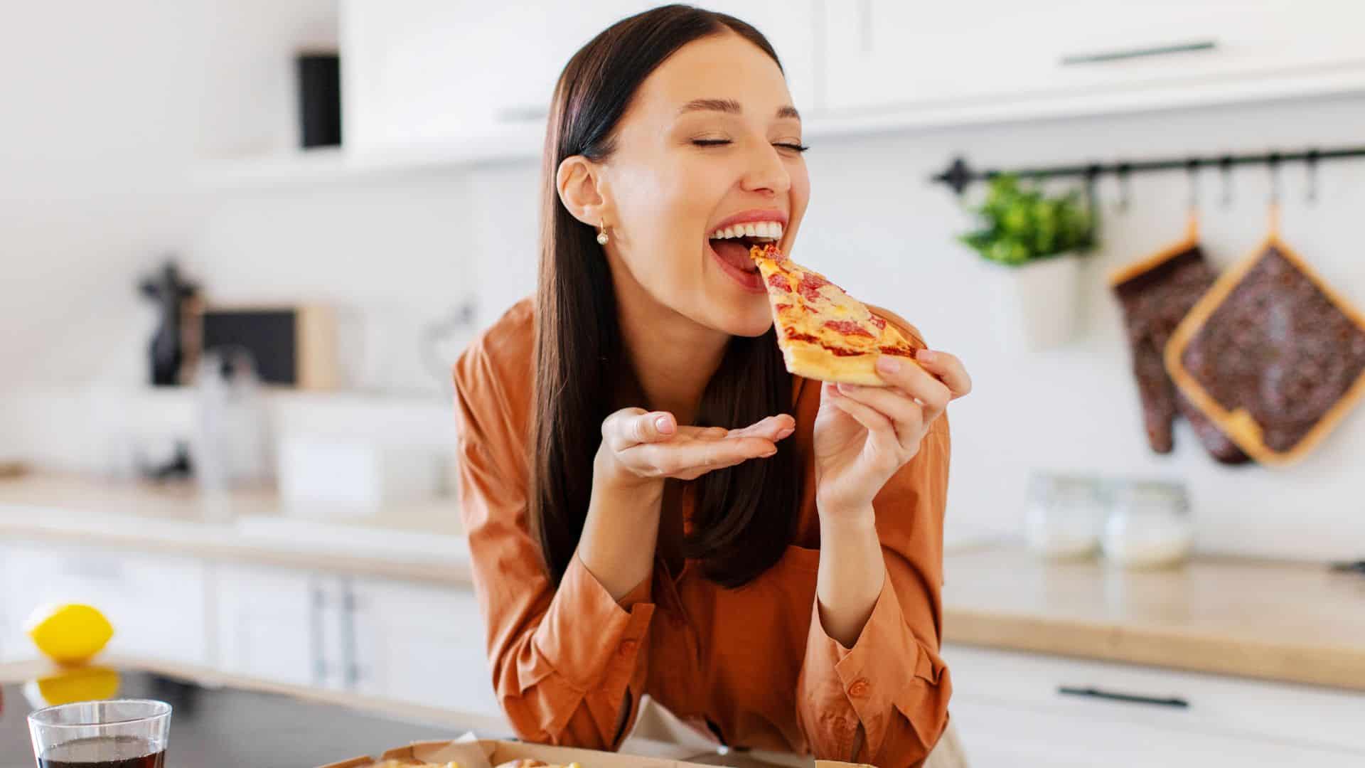 woman eating pizza