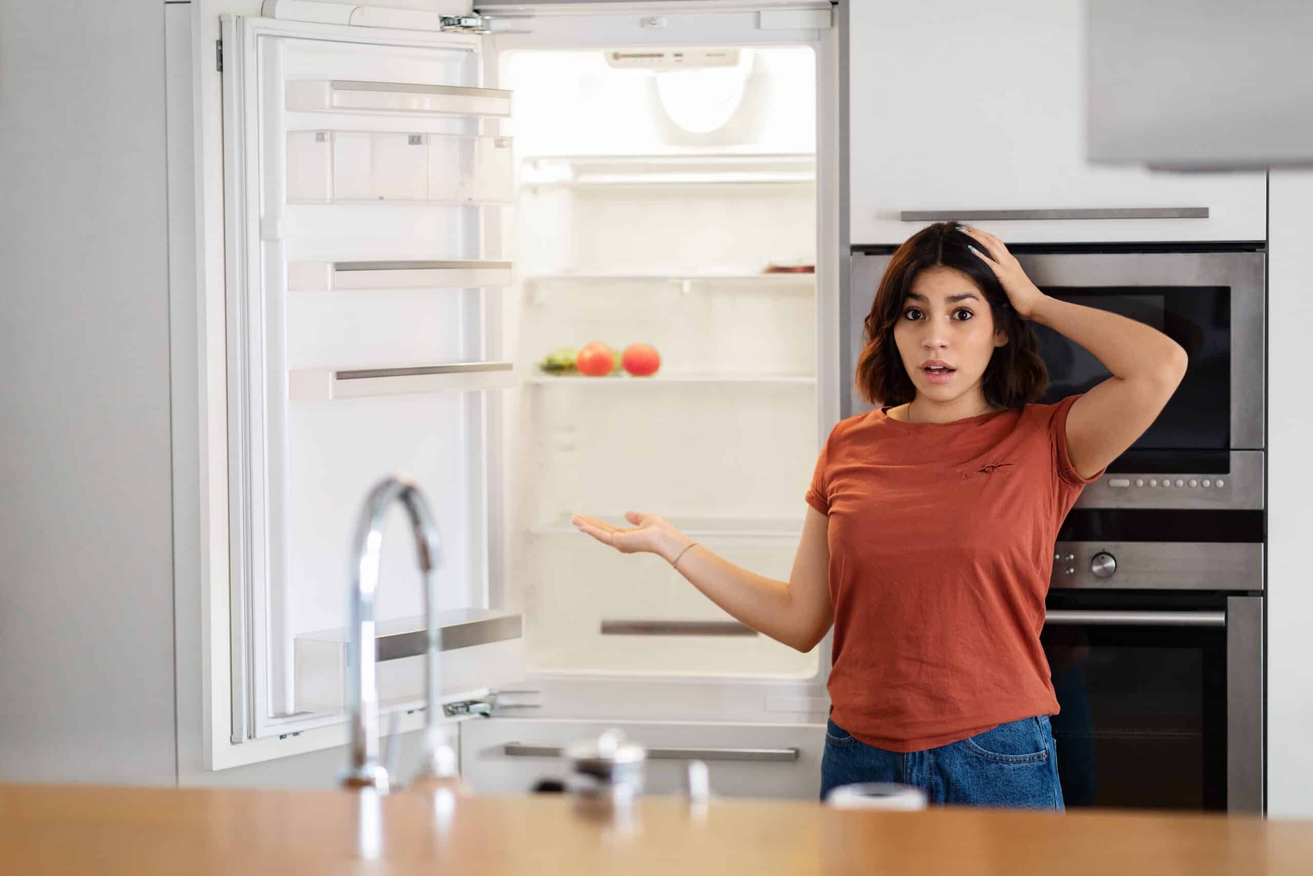 Shocked,Young,Arab,Woman,Near,Empty,Fridge,With,No,Food
