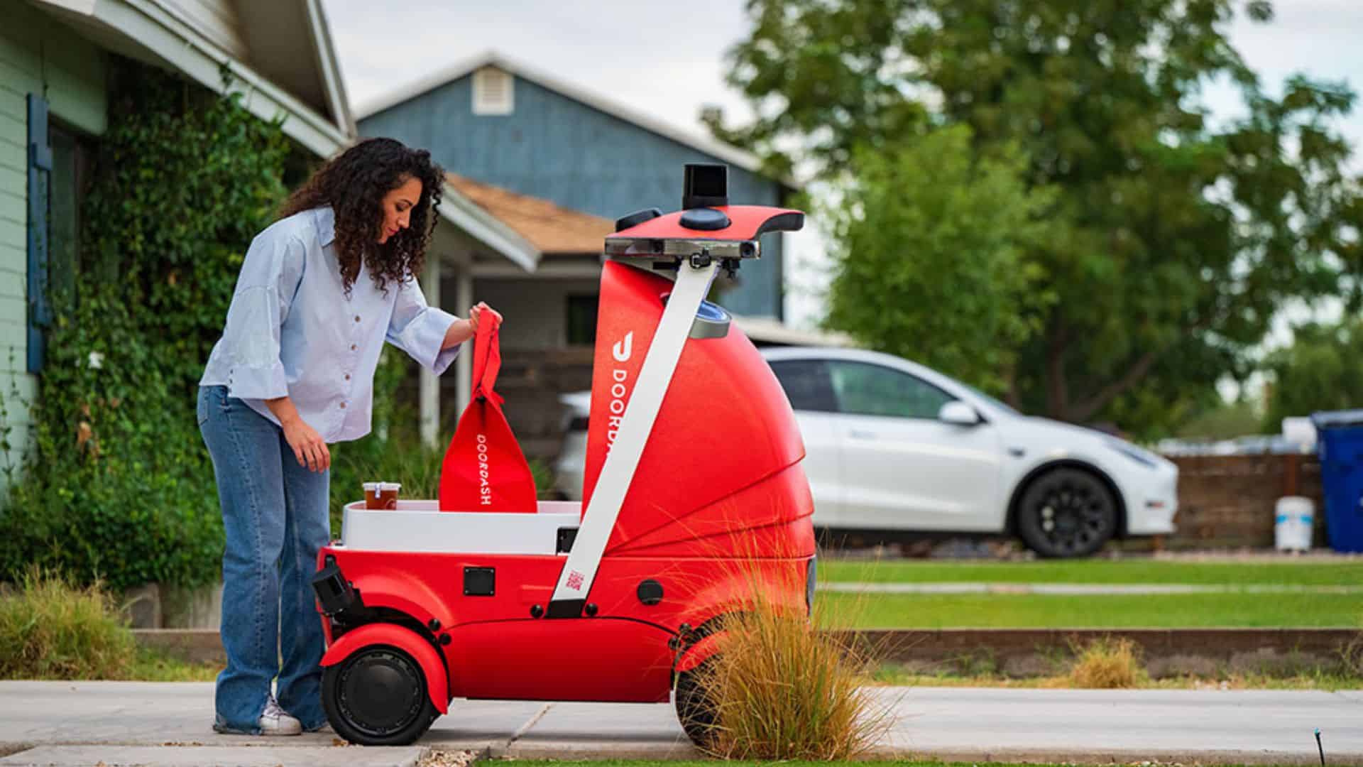 woman taking delivery from doordash dot robot