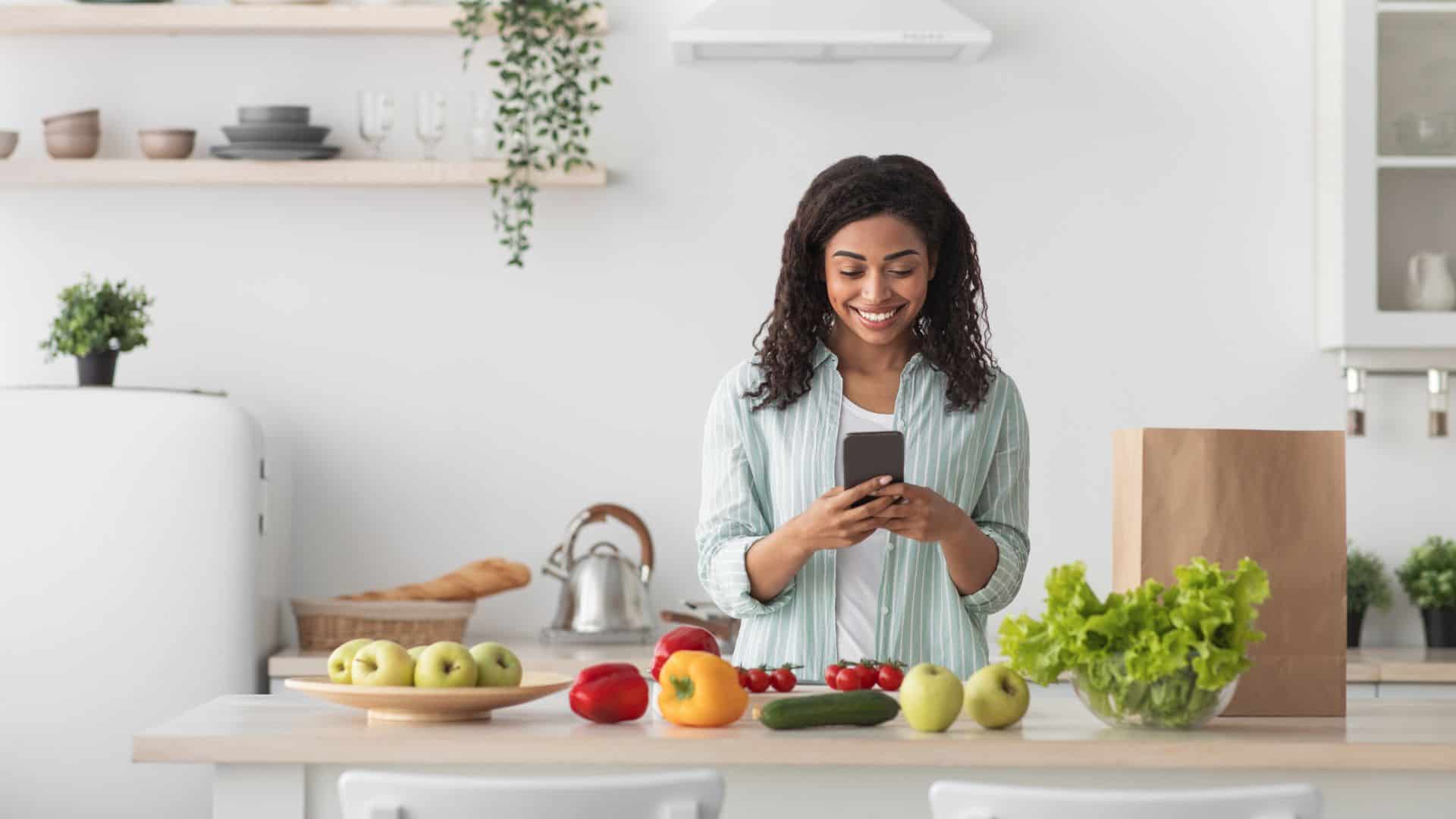 woman using phone in ktichen