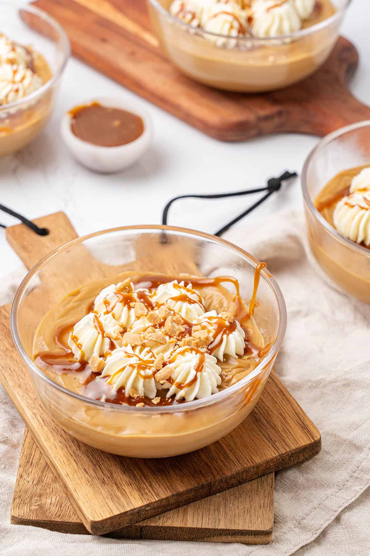 Butterscotch pudding in a glass bowl.