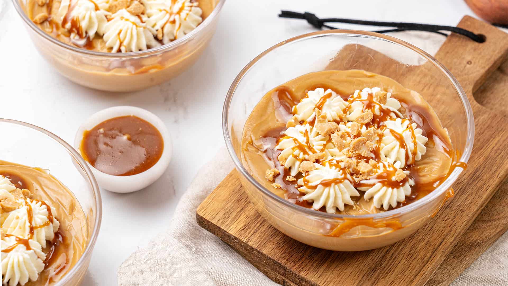 Butterscotch pudding in a glass bowl.