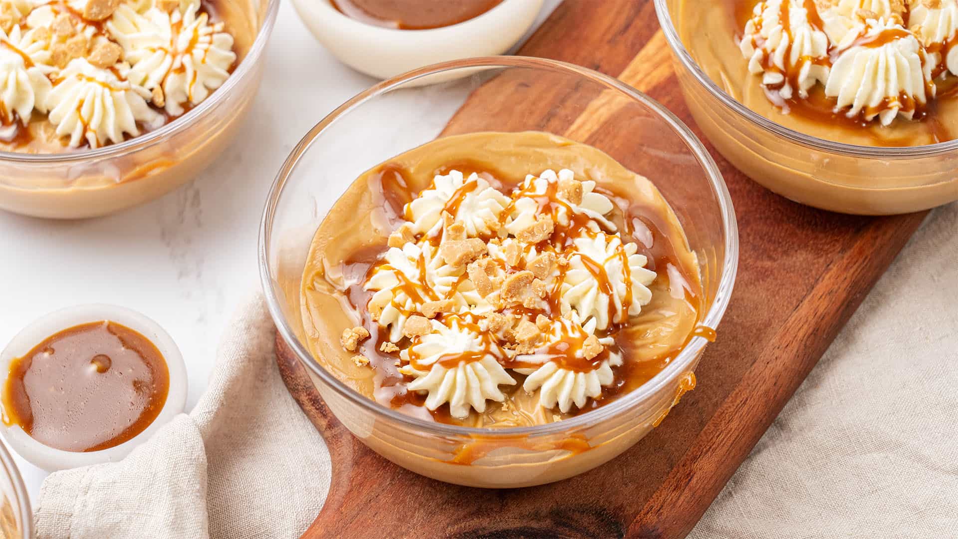 Butterscotch pudding in a glass bowl.