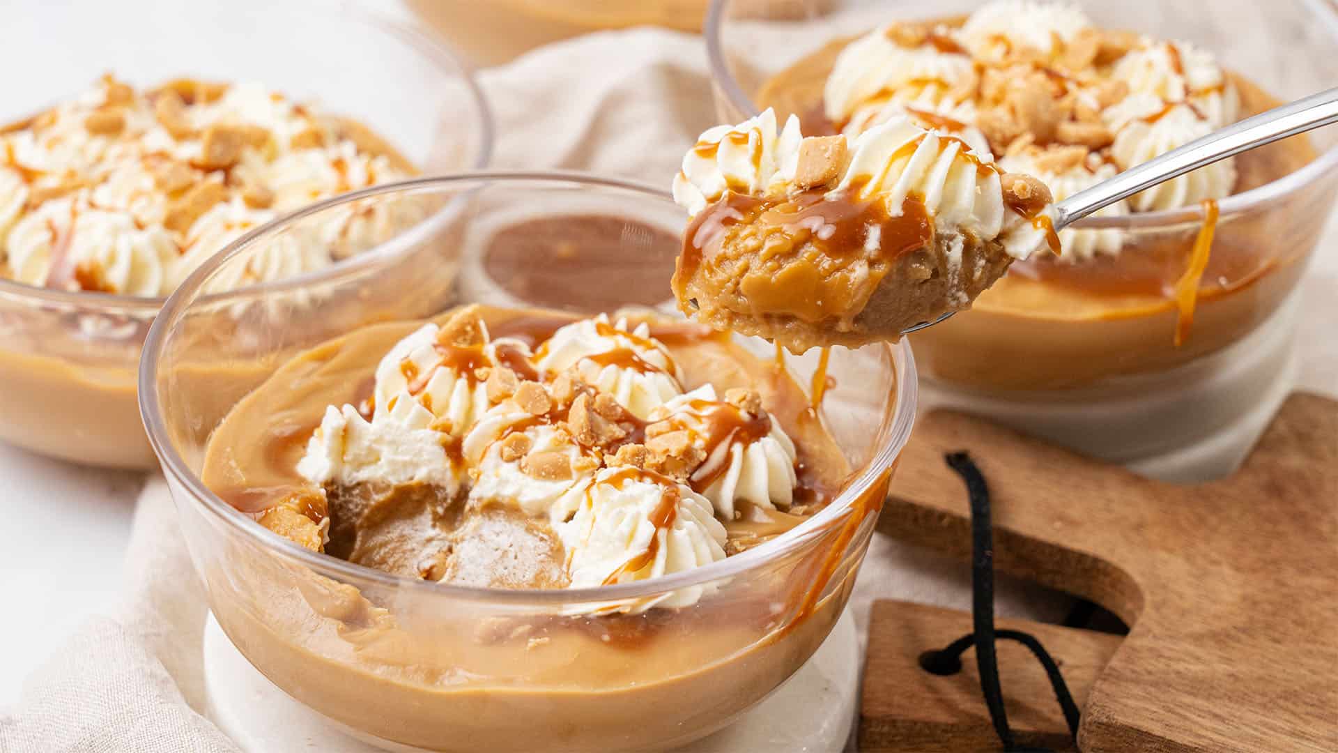 Butterscotch pudding in a glass bowl.