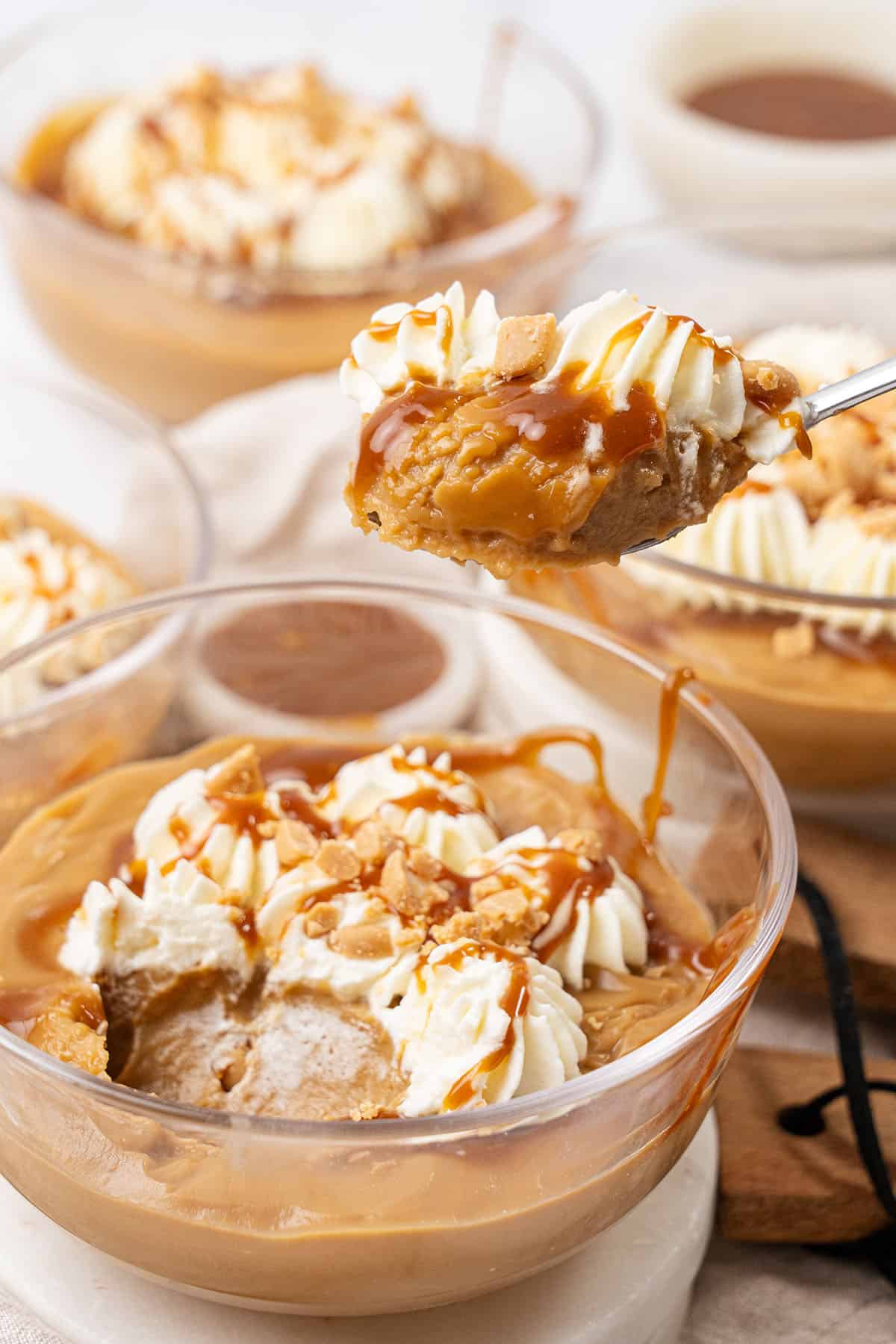 Butterscotch pudding in a glass bowl.