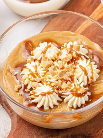 Butterscotch pudding in a glass bowl.