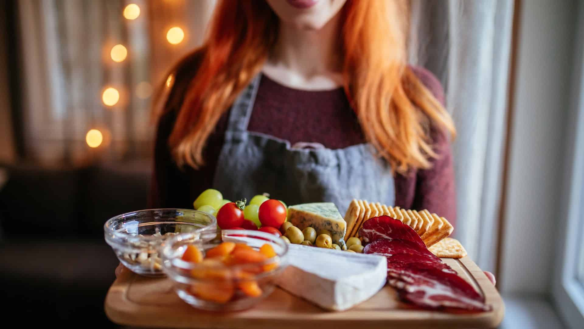 Happy ginger girl bringing food for dinner.