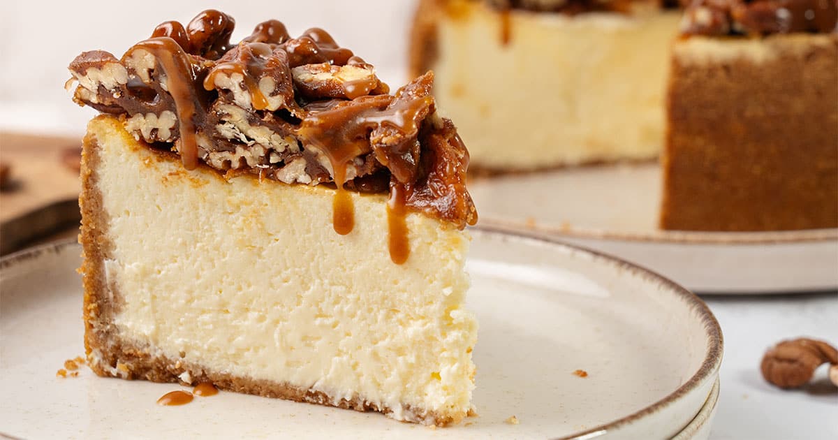A slice of Pecan Pie cheesecake on a plate.