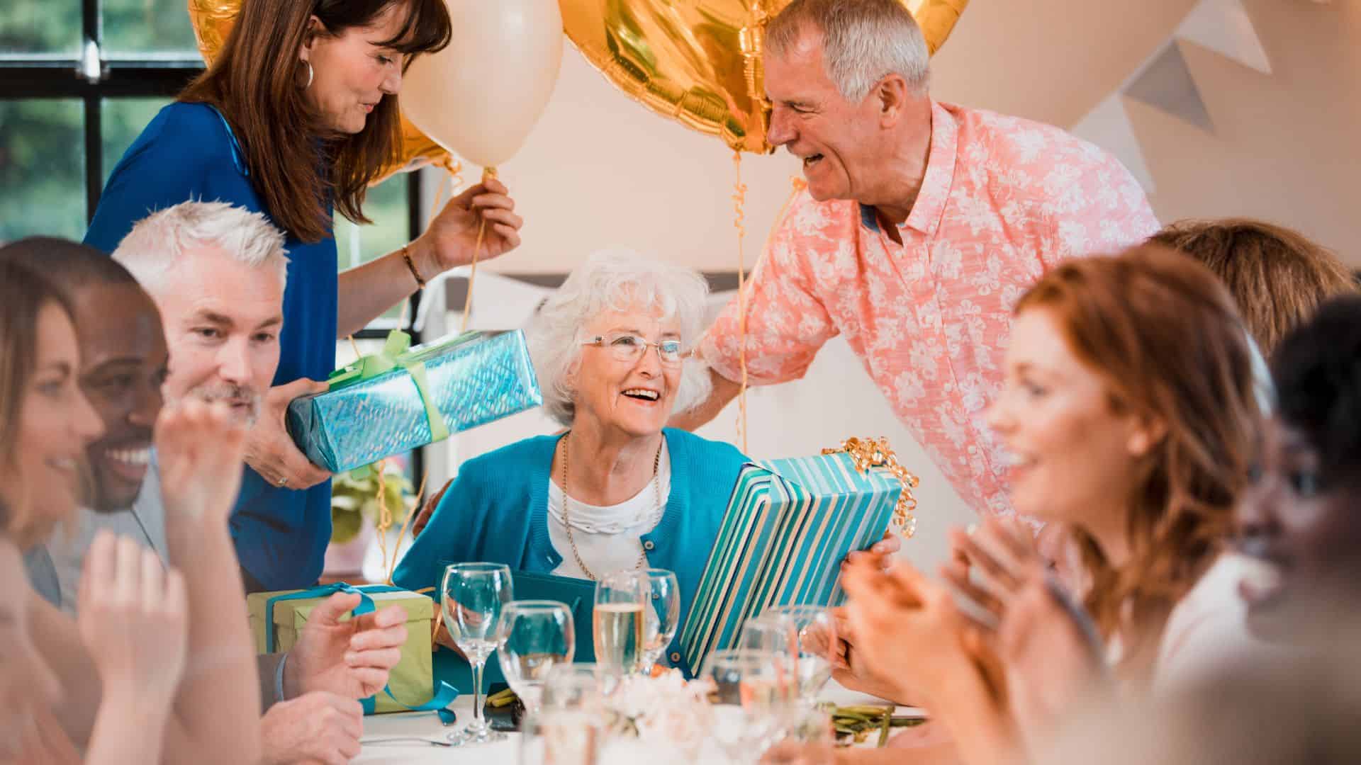 Senior woman is surprised with a birthday party by her friends and family.