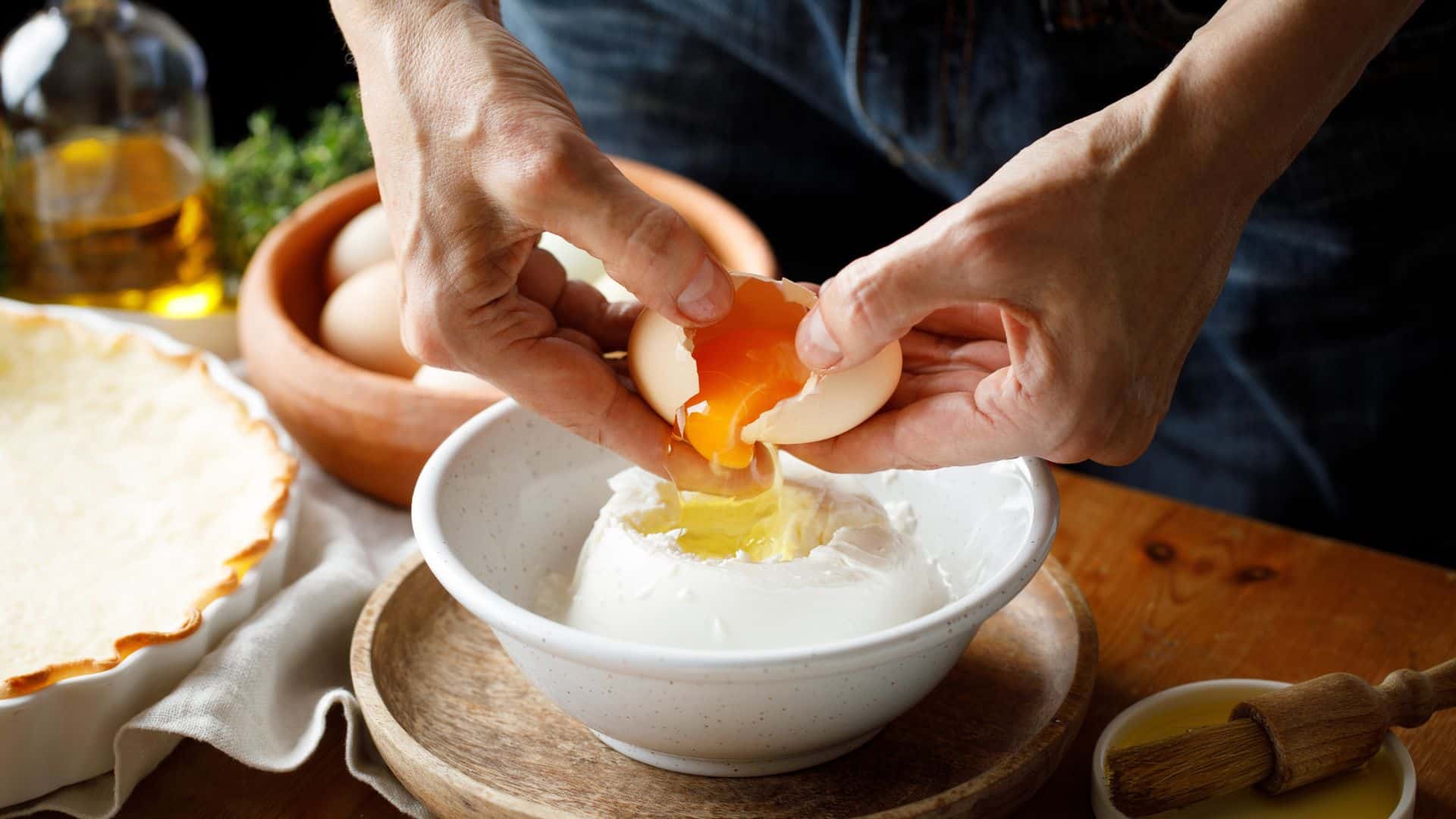 adding eggs to the cheese