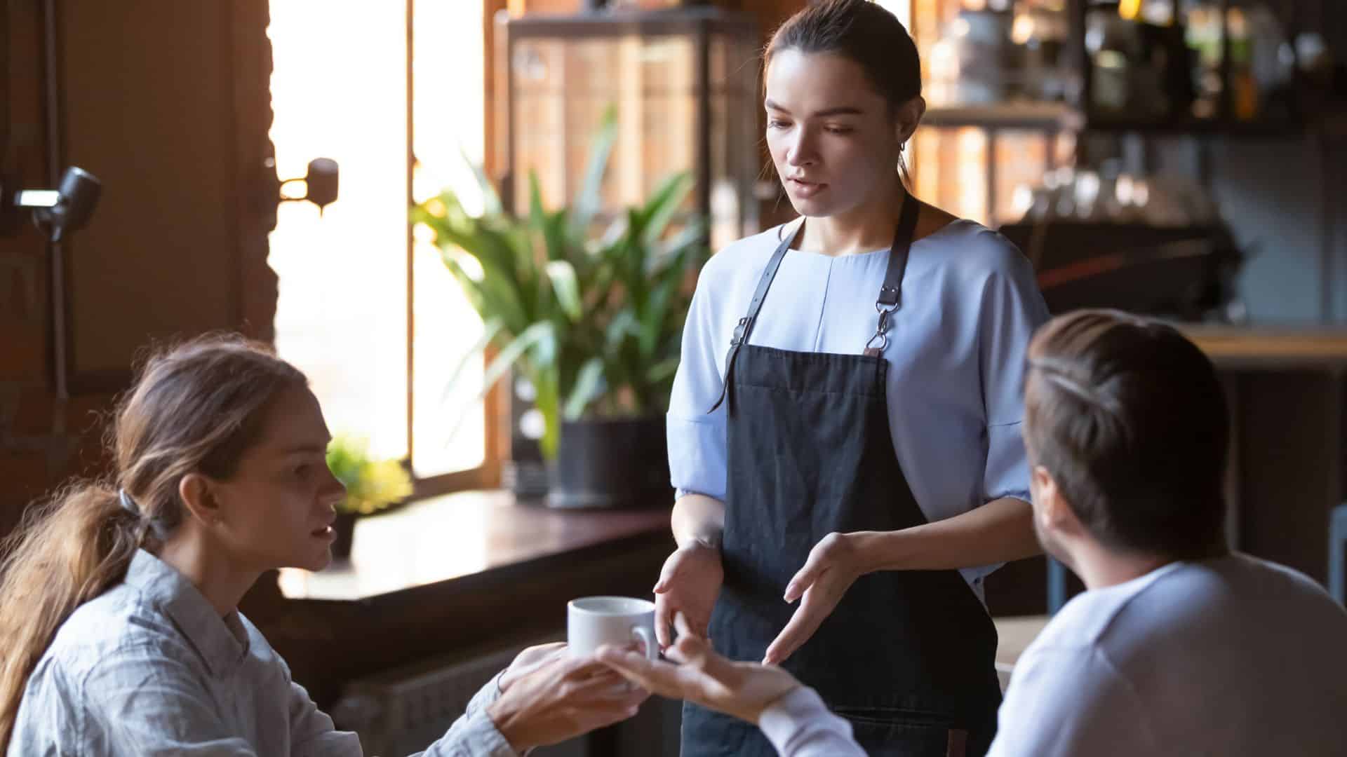angry couple talking with waiter