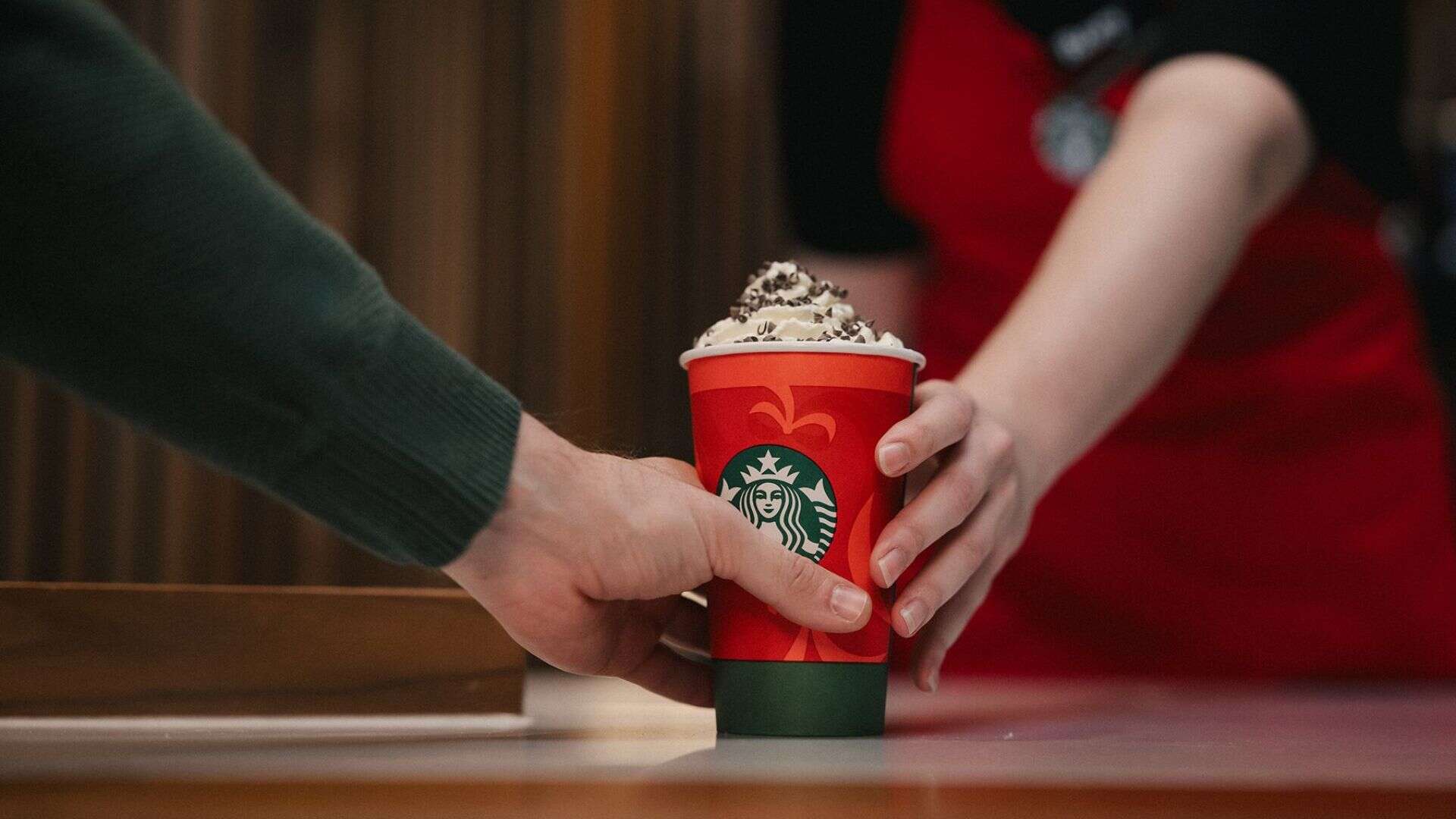 barista giving peppermint mocha to a customer at starbucks