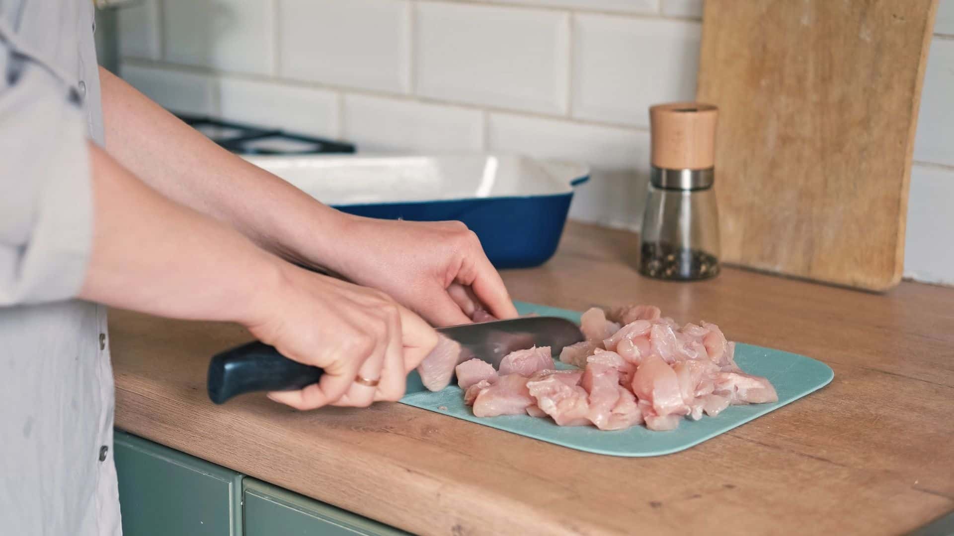 cutting raw chicken