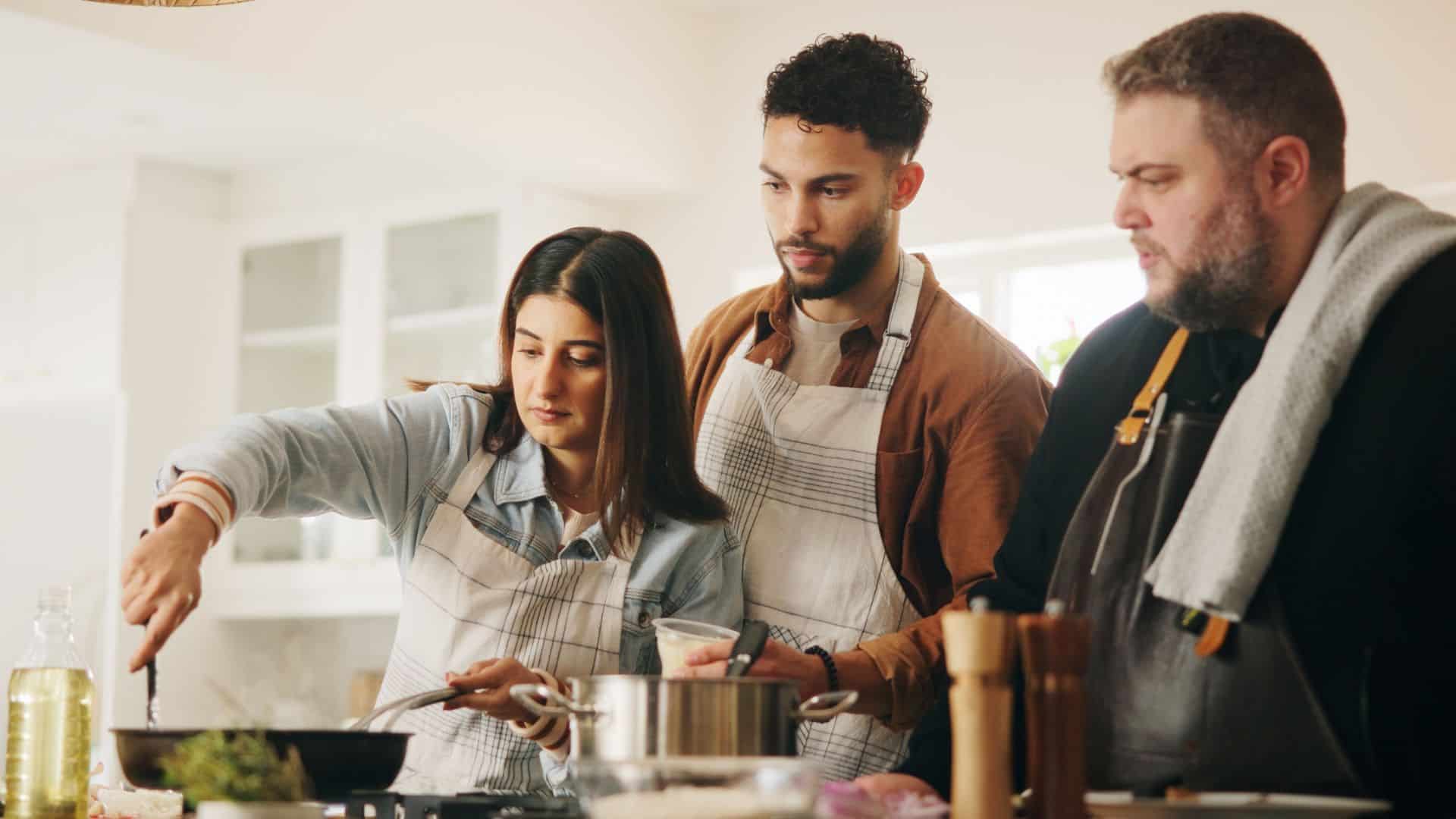 men watching woman cook