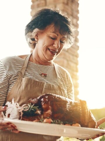 woman holding thanksgiving turkey outdoor