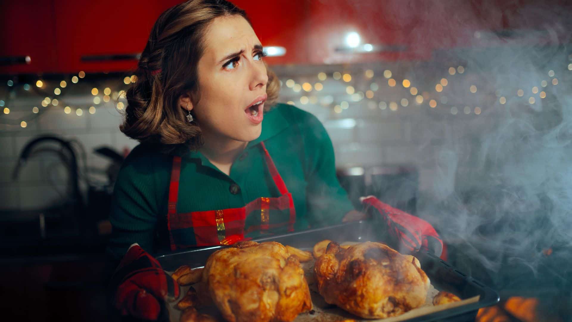 woman holding turkey tray upset with burning smoke
