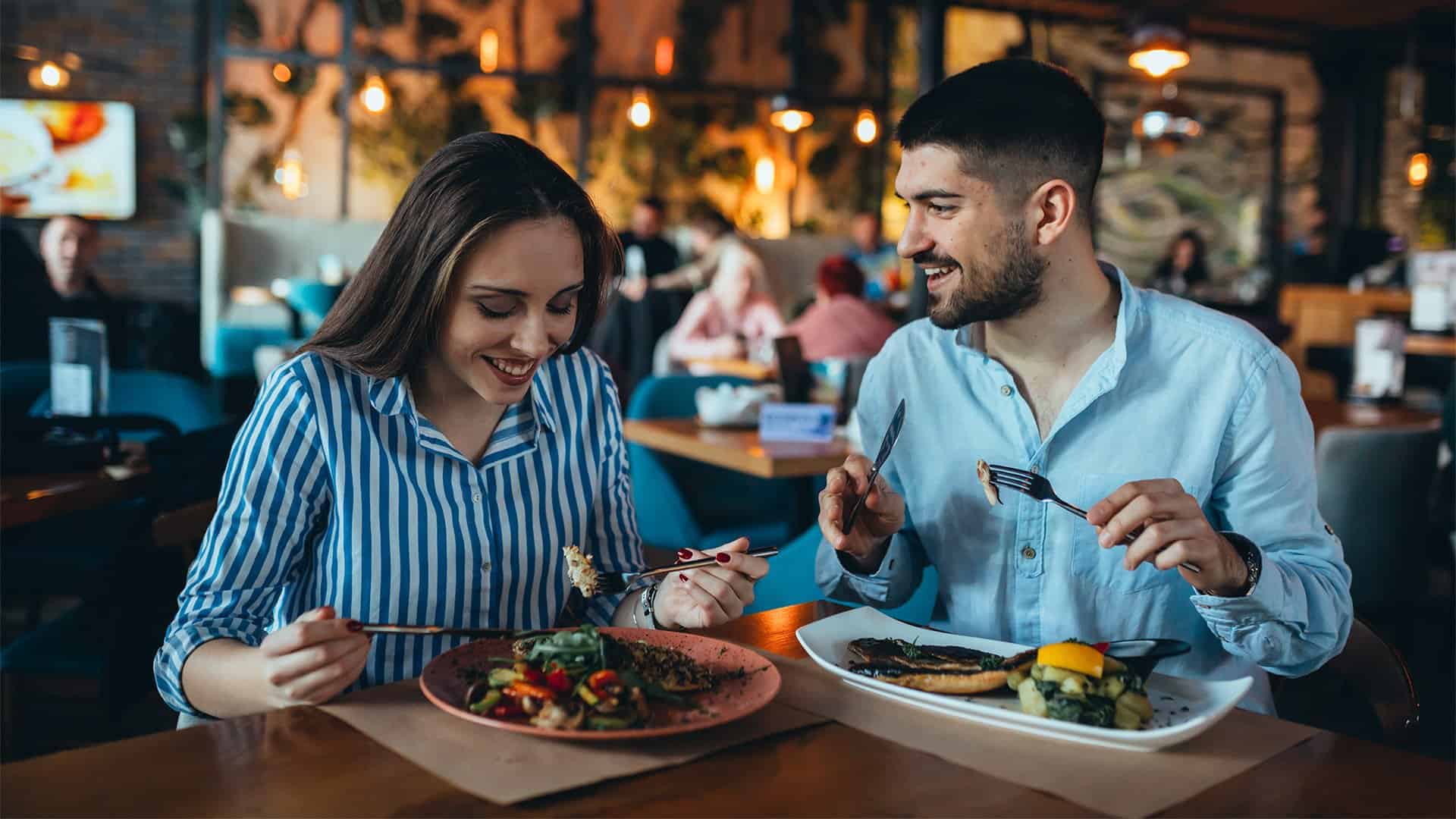 Couple eating dinner in a restaurant.