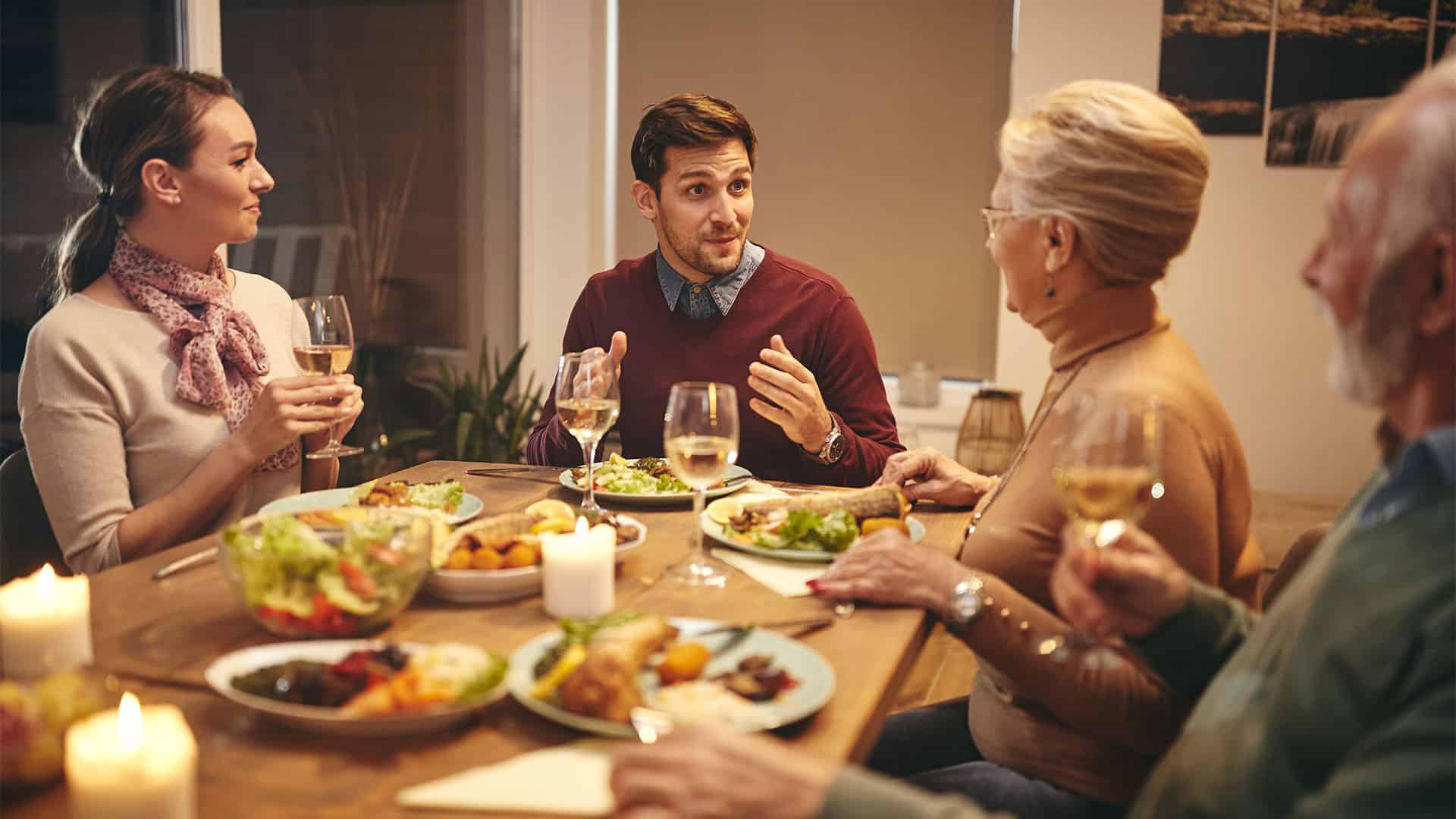 Couple having dinner with family.