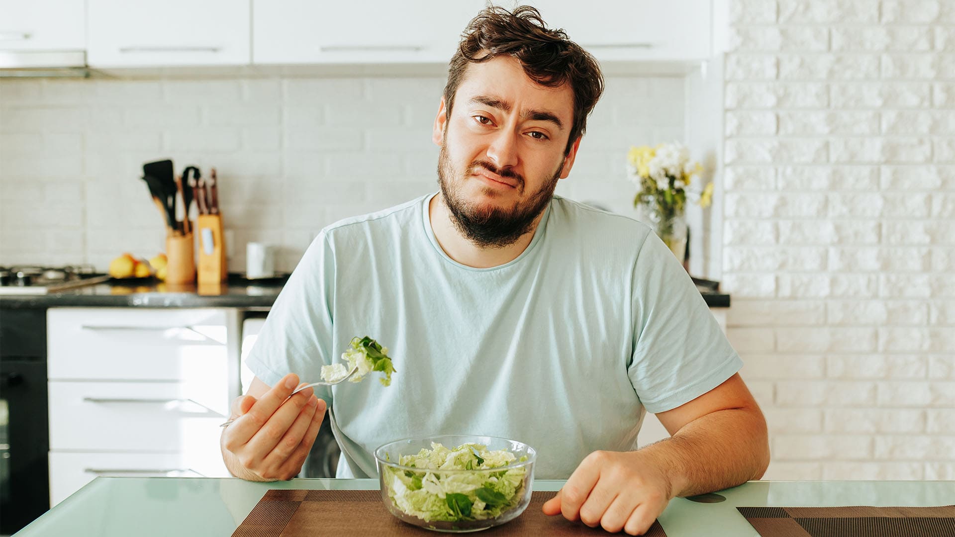 man eating a salad.