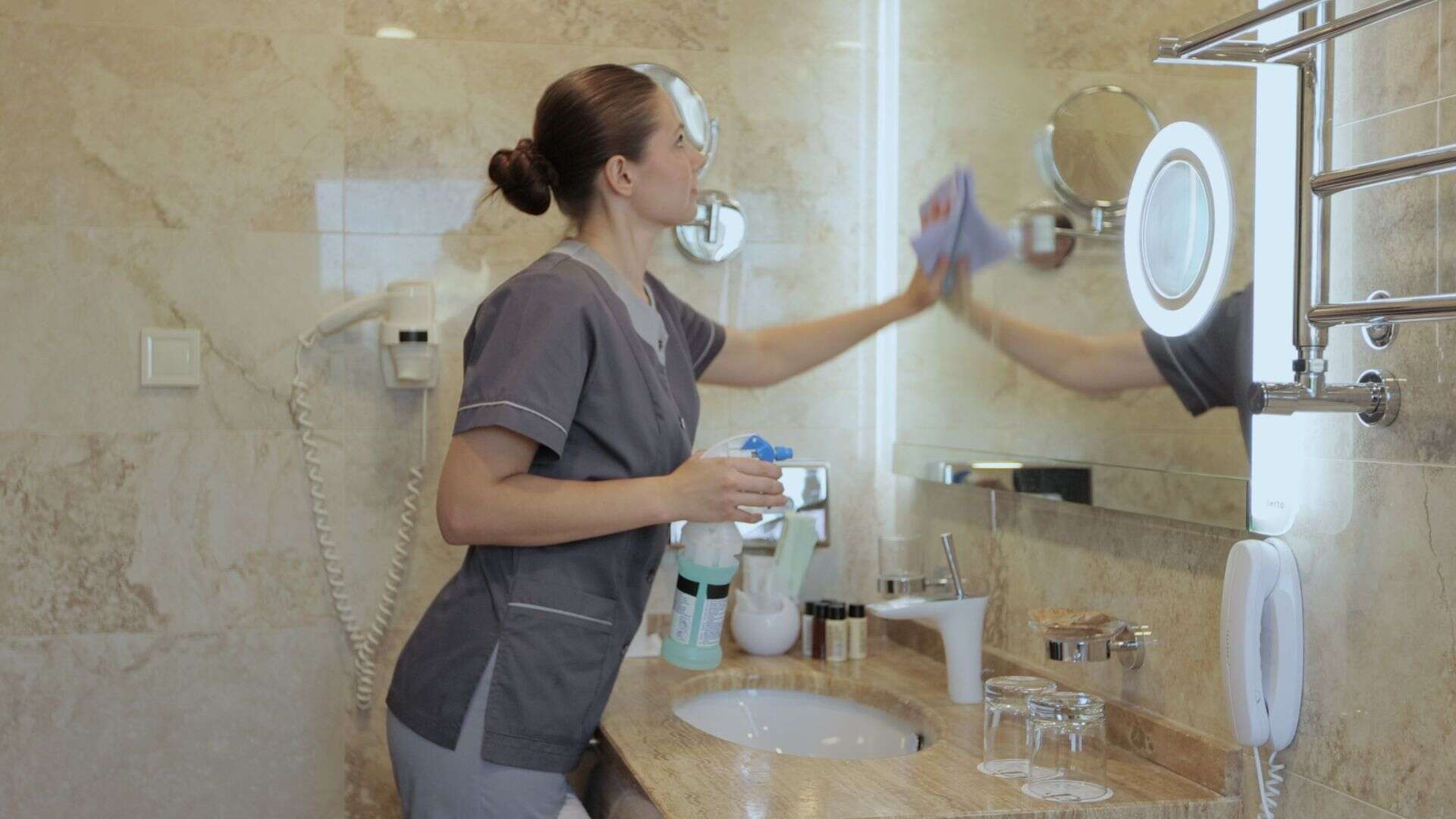 woman cleaning bathroom