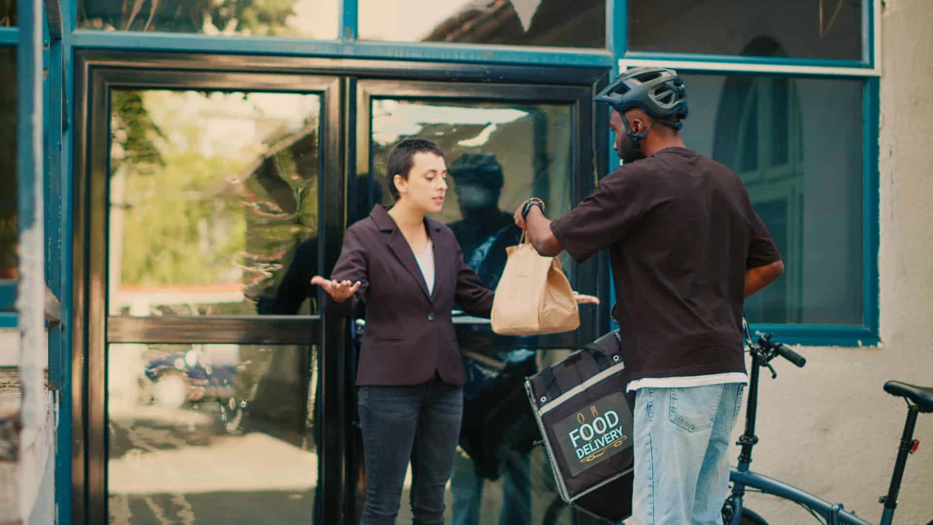 Woman arguing at food delivery worker