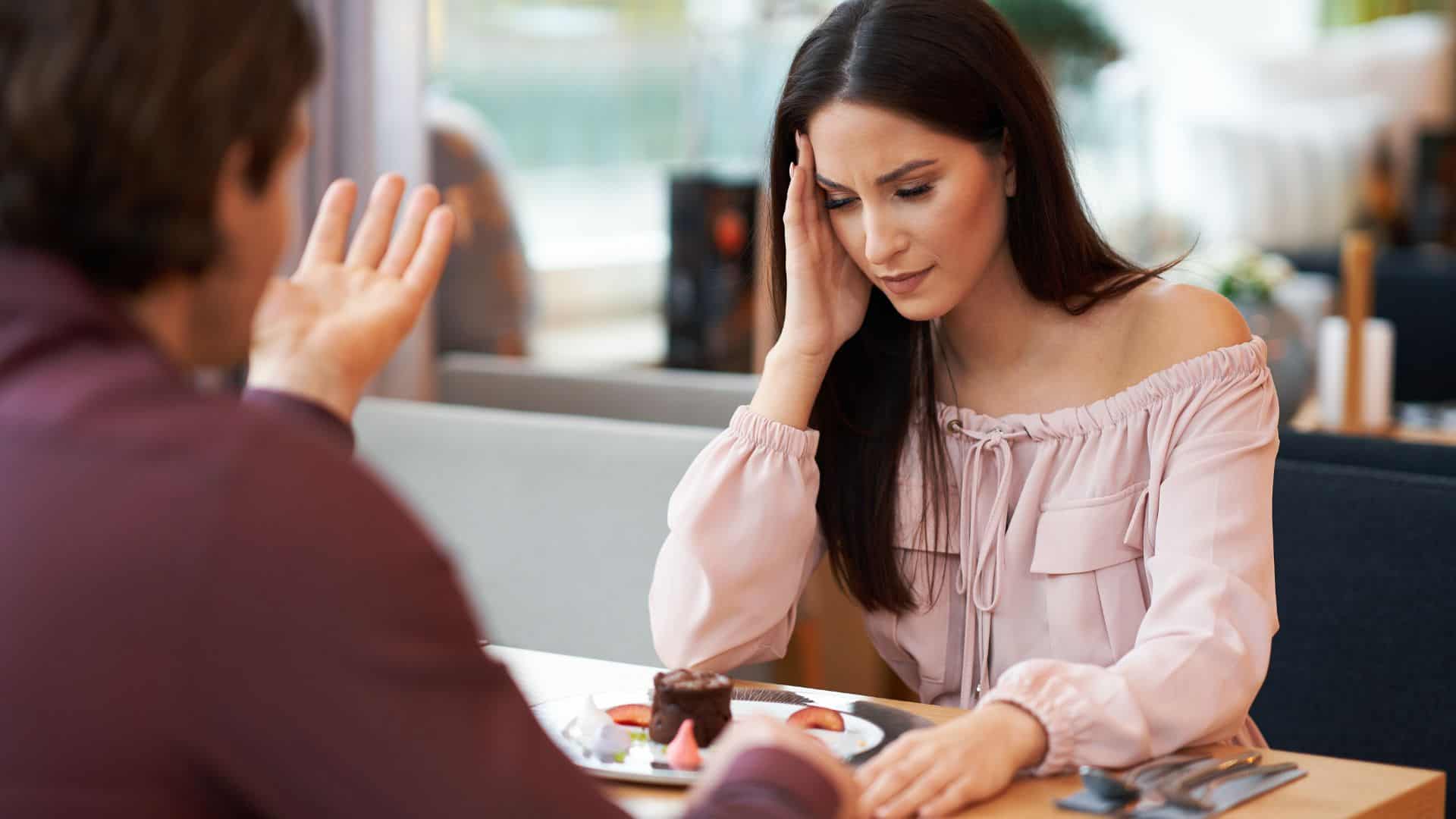 Young Couple having argument In Cafe