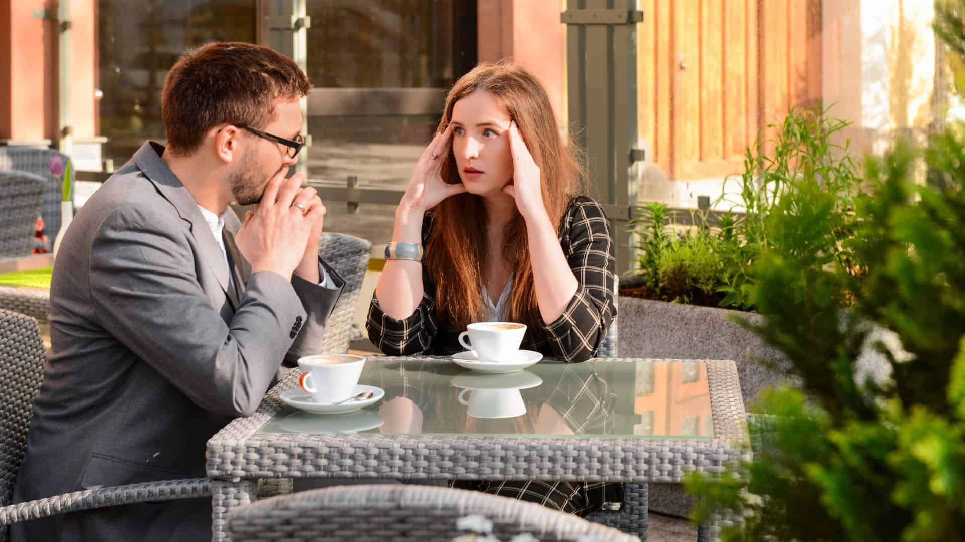 couple sitting in restaurant arguing