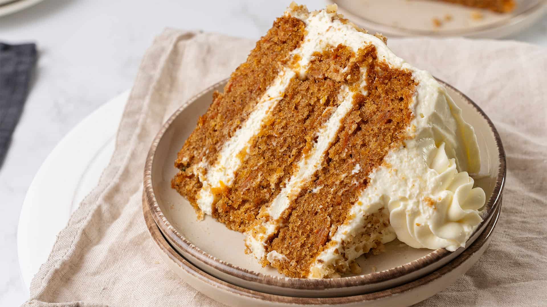 A slice of carrot cake on a plate.