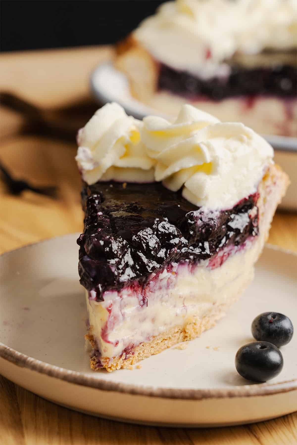 A slice of Blueberry Cream Pie on a plate.