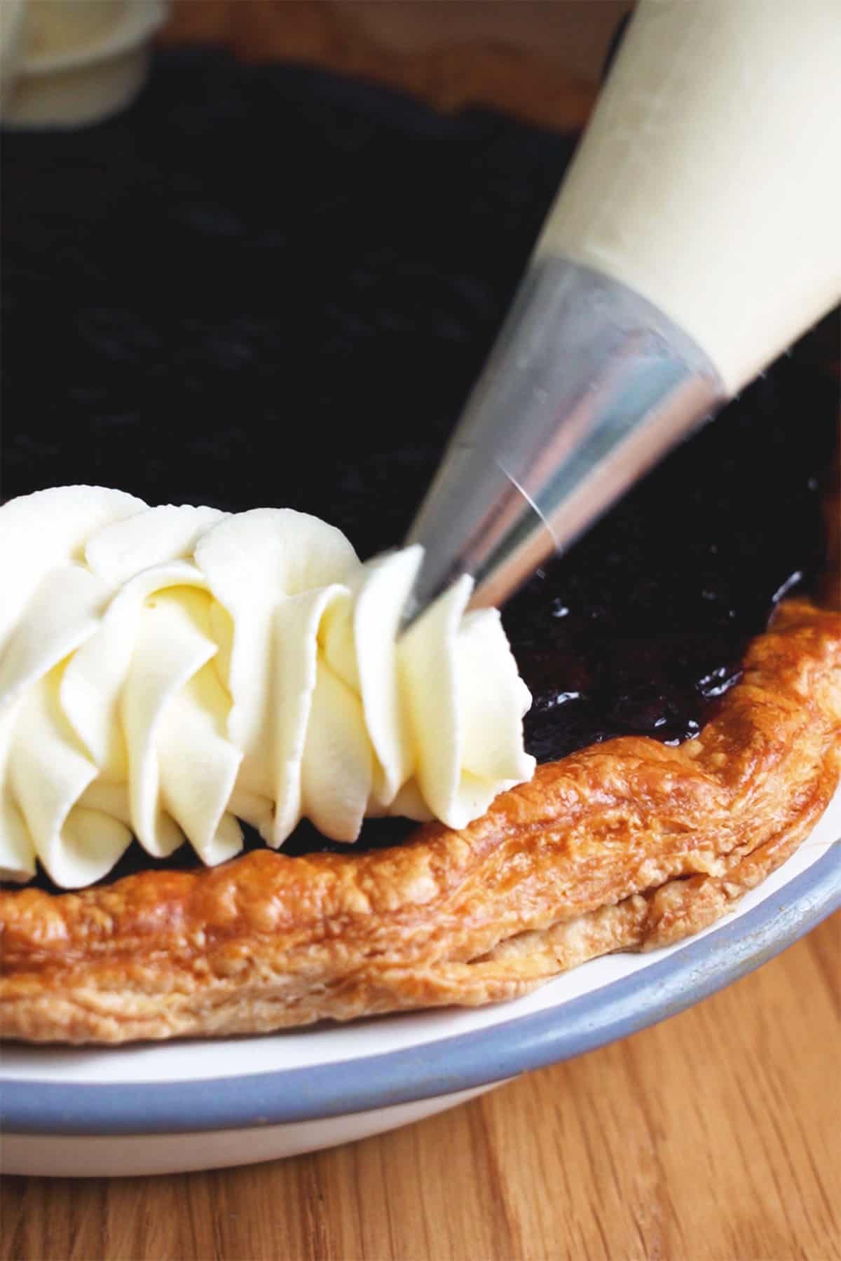 Piping decoration on the Blueberry Cream Pie.