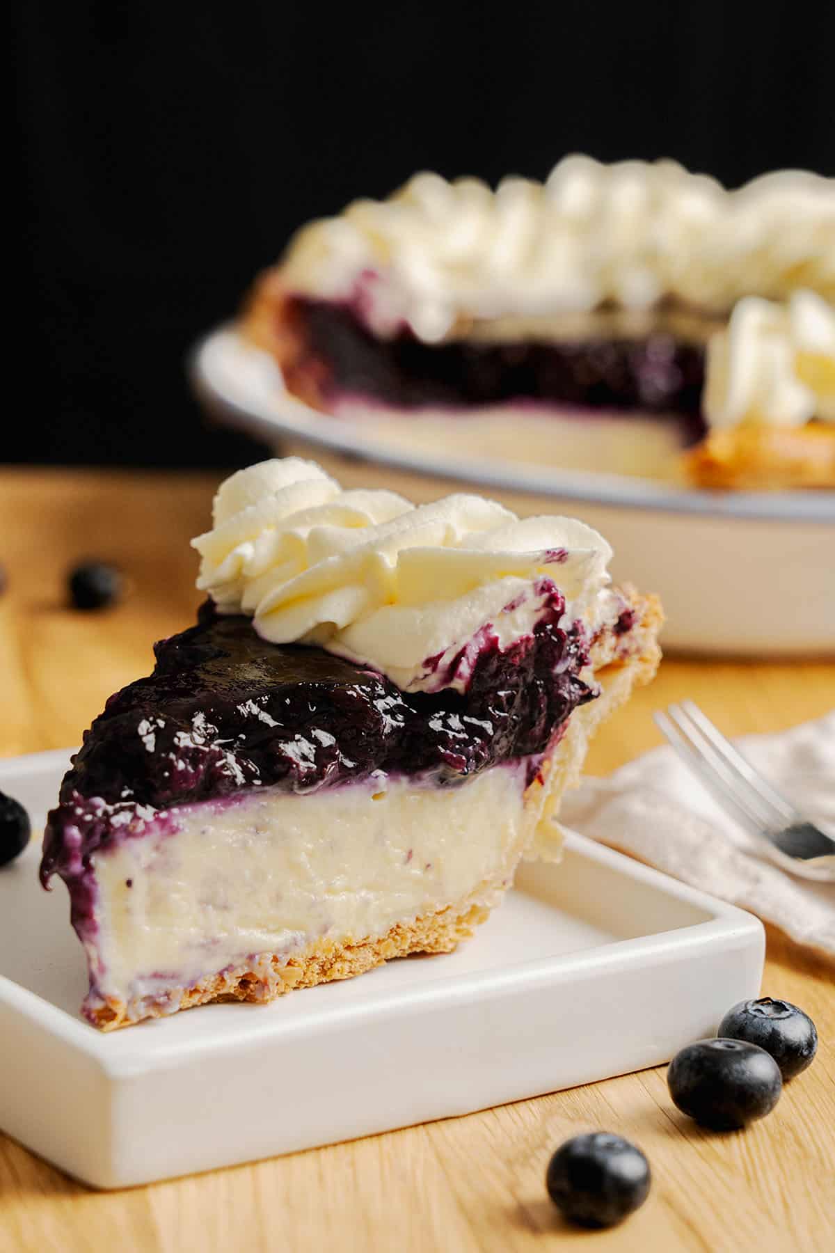 A slice of Blueberry Cream Pie on a plate.