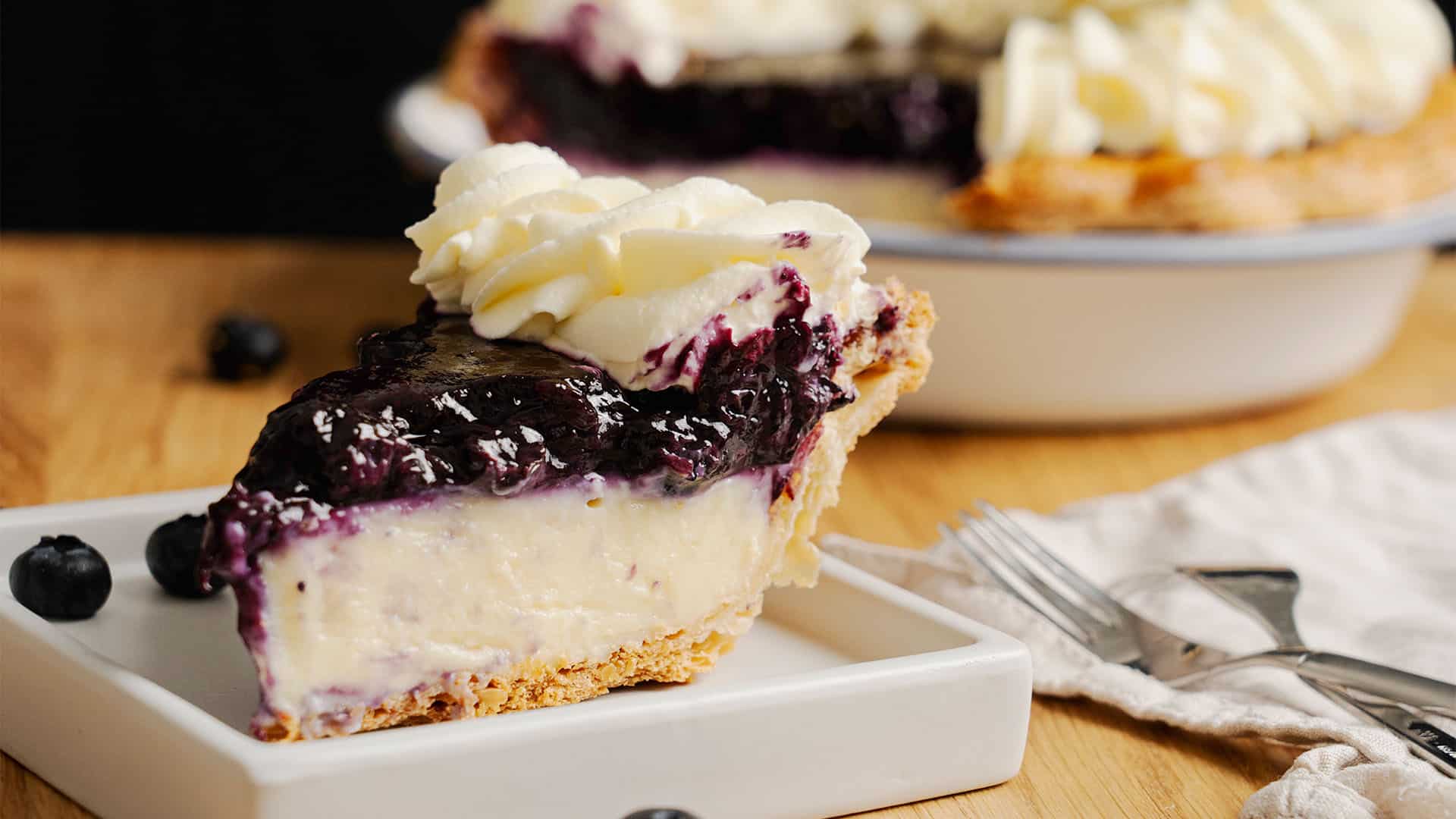 A slice of Blueberry Cream Pie on a plate.
