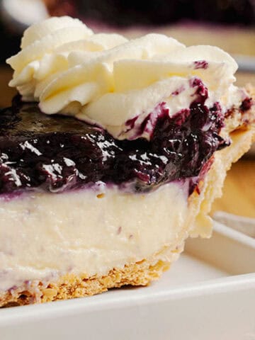 A slice of Blueberry Cream Pie on a plate.