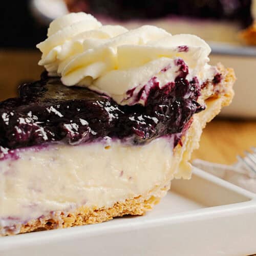 A slice of Blueberry Cream Pie on a plate.