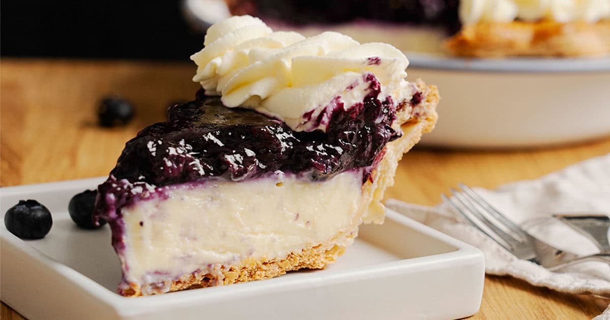 A slice of Blueberry Cream Pie on a plate.