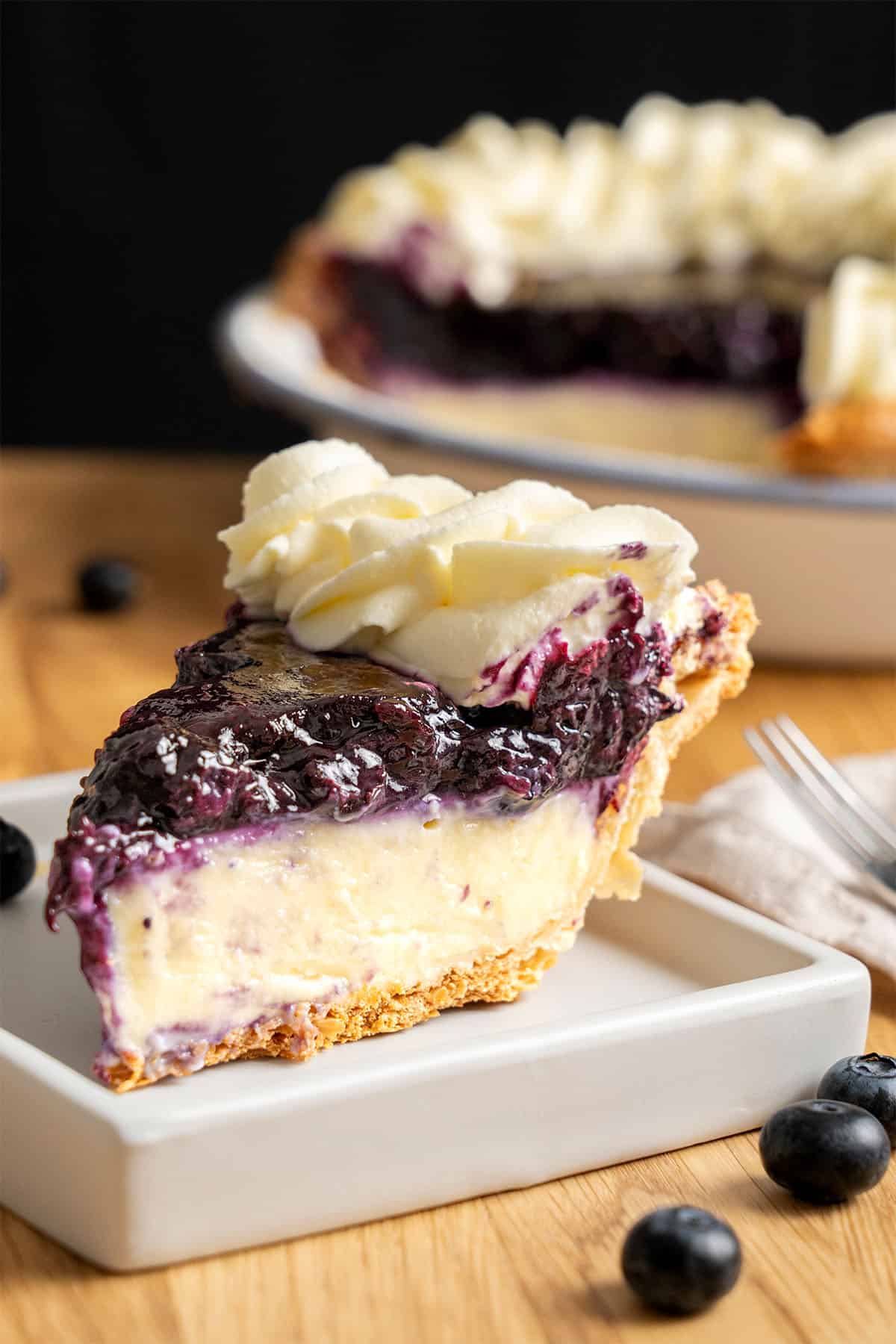 A slice of Blueberry Cream Pie on a plate.